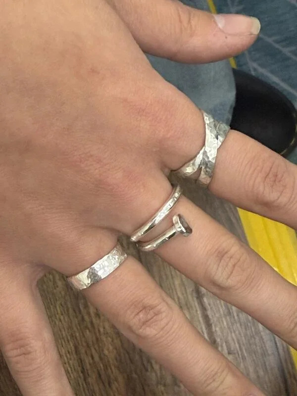 outstretched fingers with 3 rings