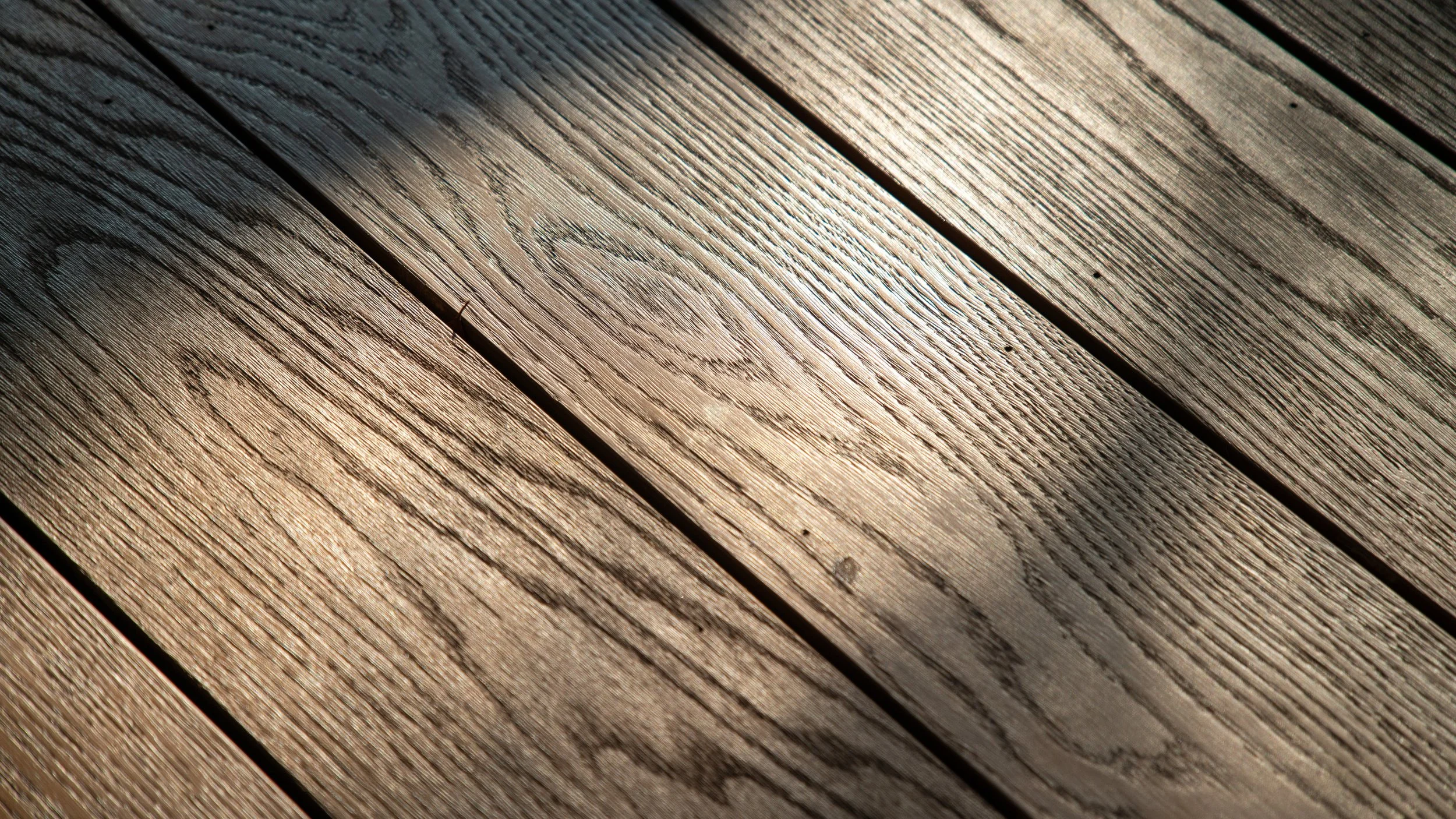 Close-up of wooden planks with visible grain patterns and knots.