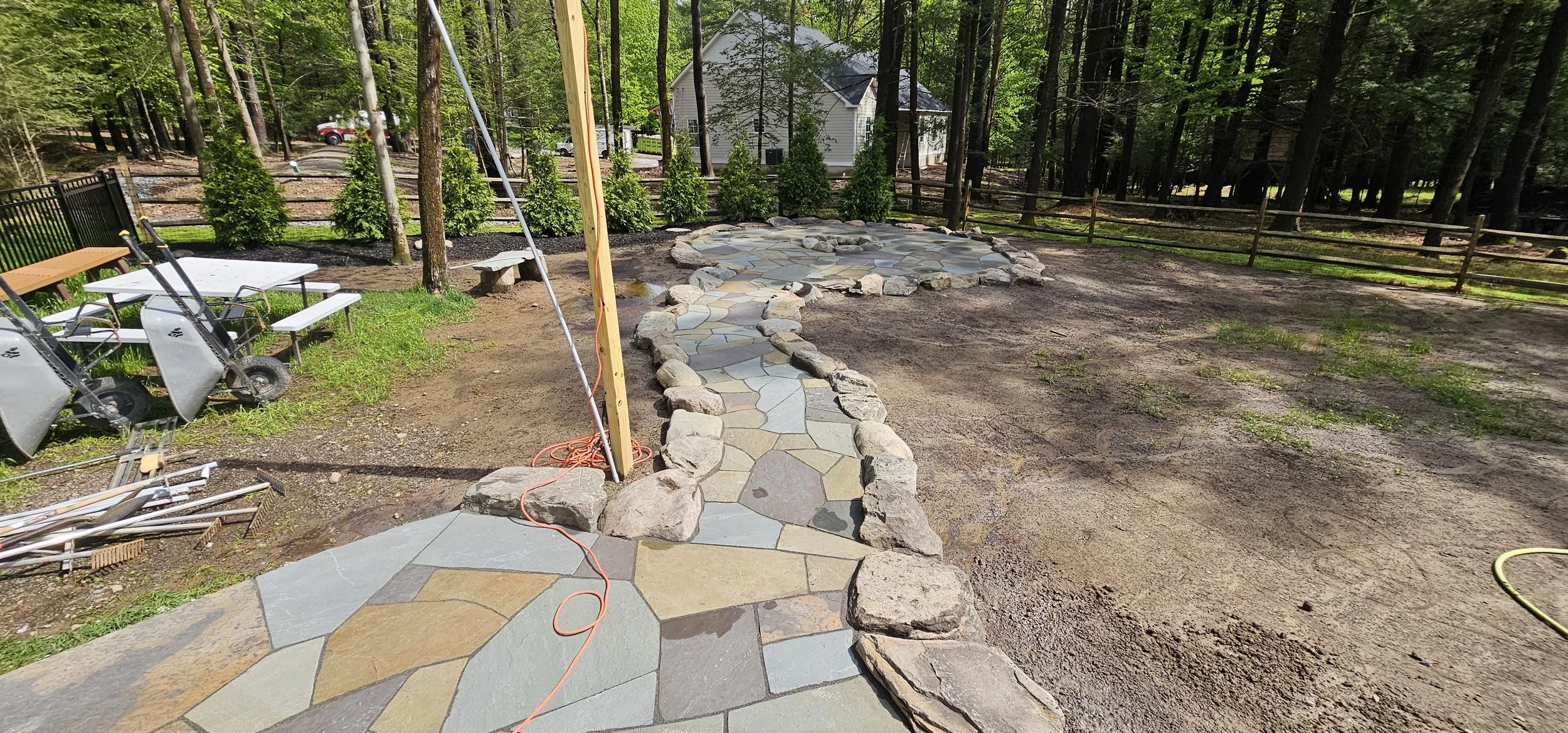 scrolling walkway to a cozy bluestone patio