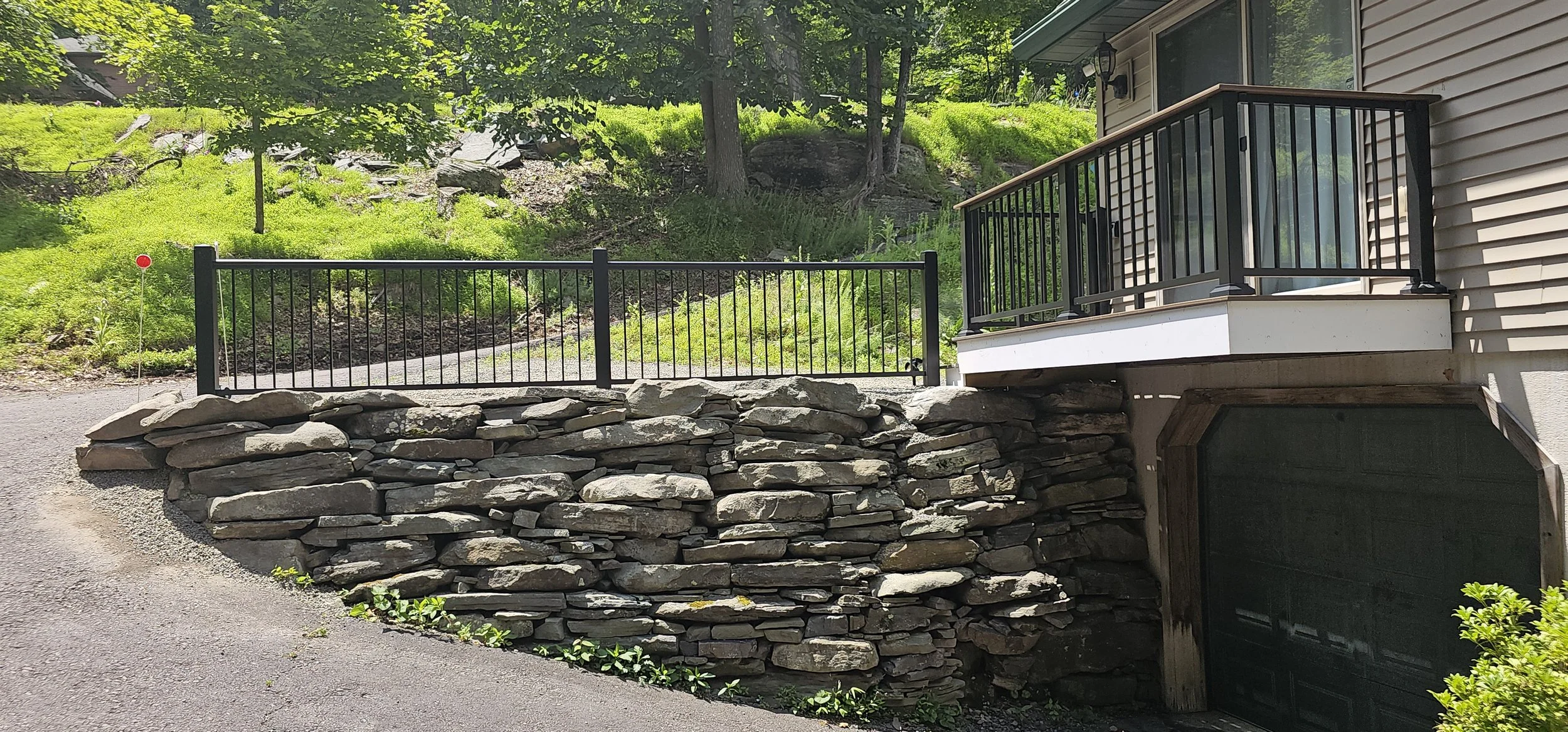 Handrail atop boulder wall