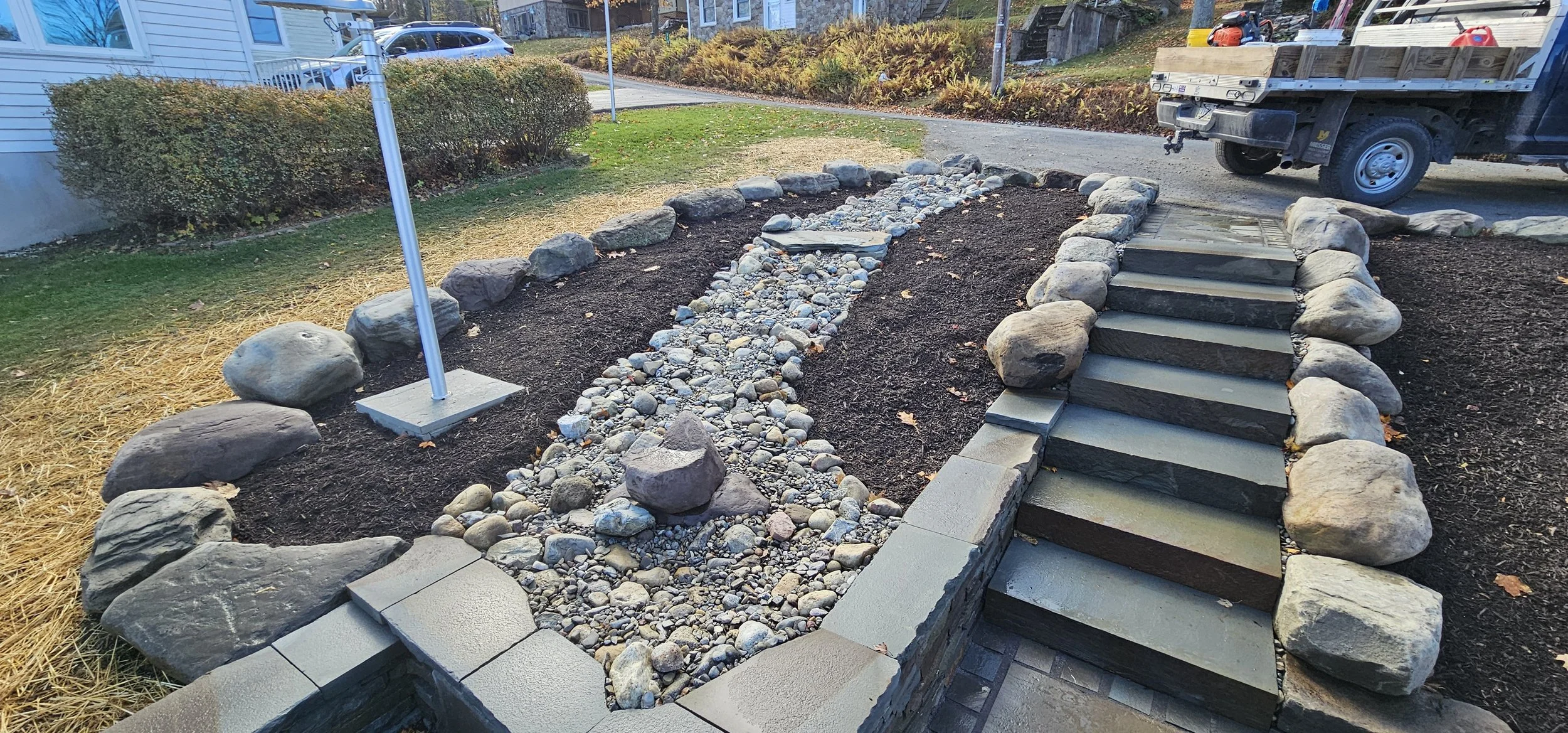 Dry creek bed design in planting bed