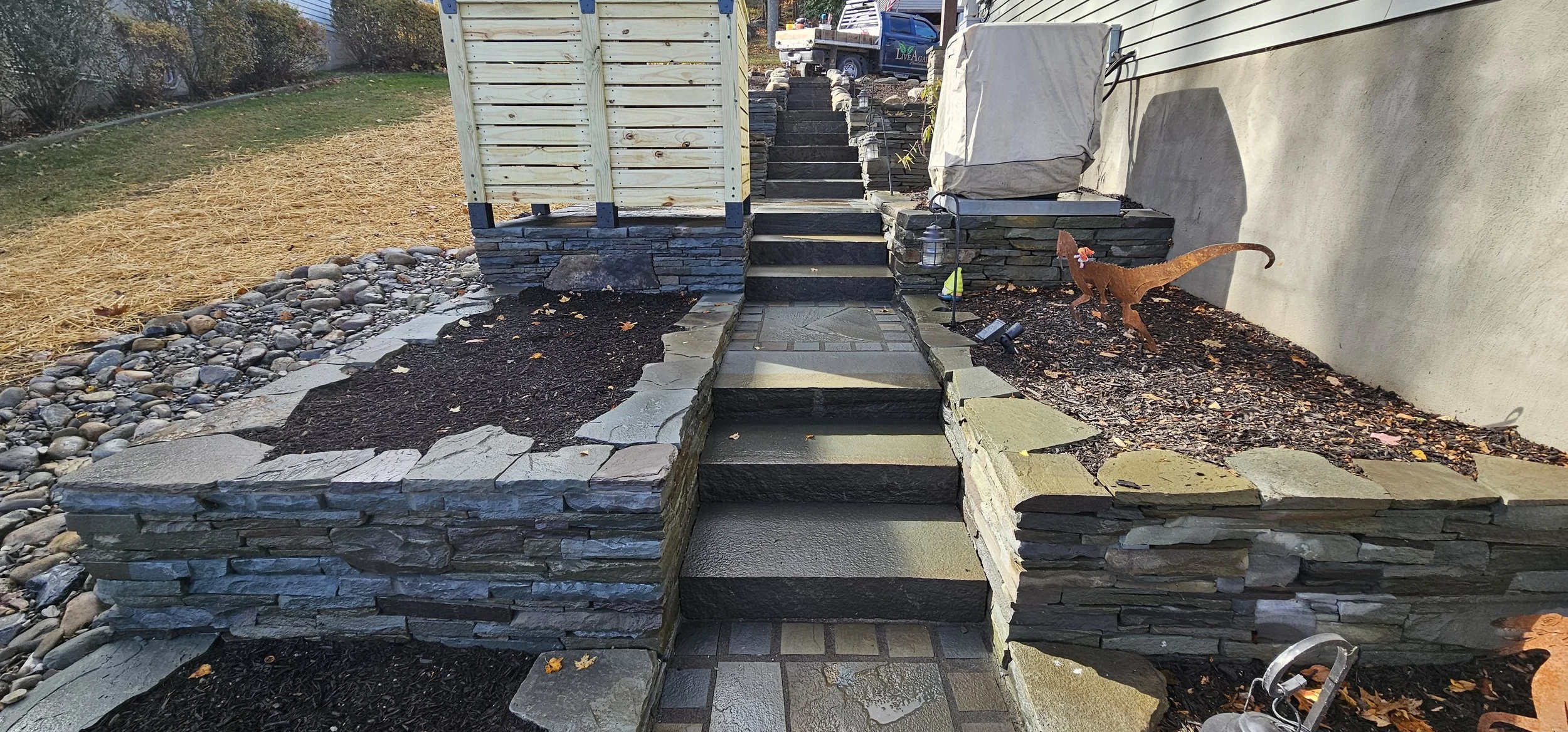 Bluestone steps with tiered stacked stone garden beds
