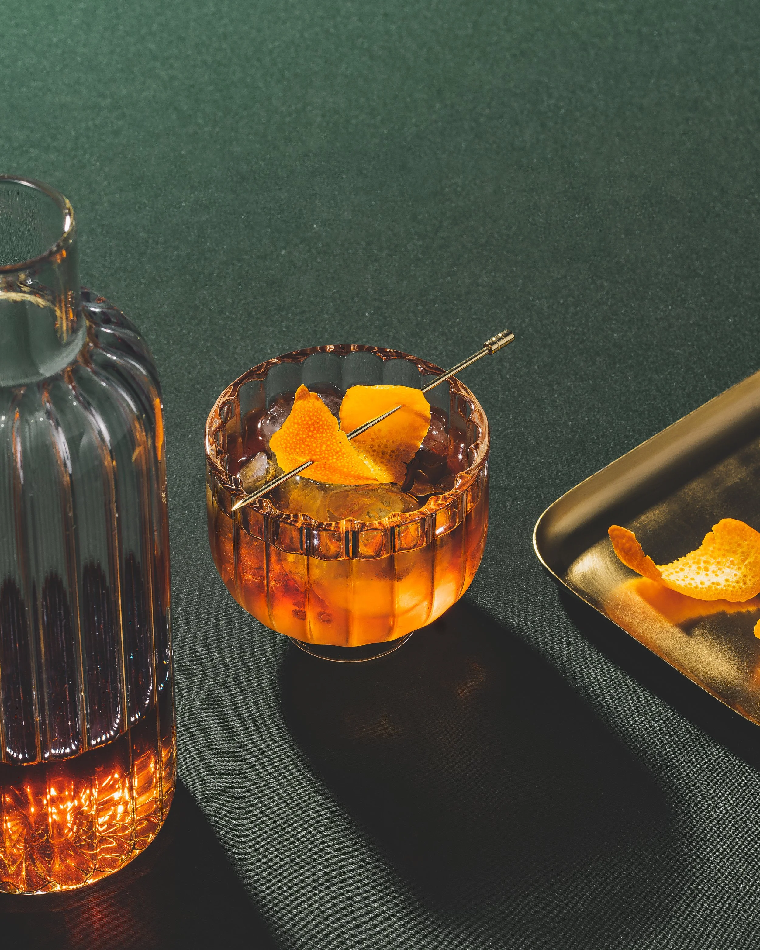 Ceesay handmade glass and Vivienne handmade decanter with orange cocktail in them