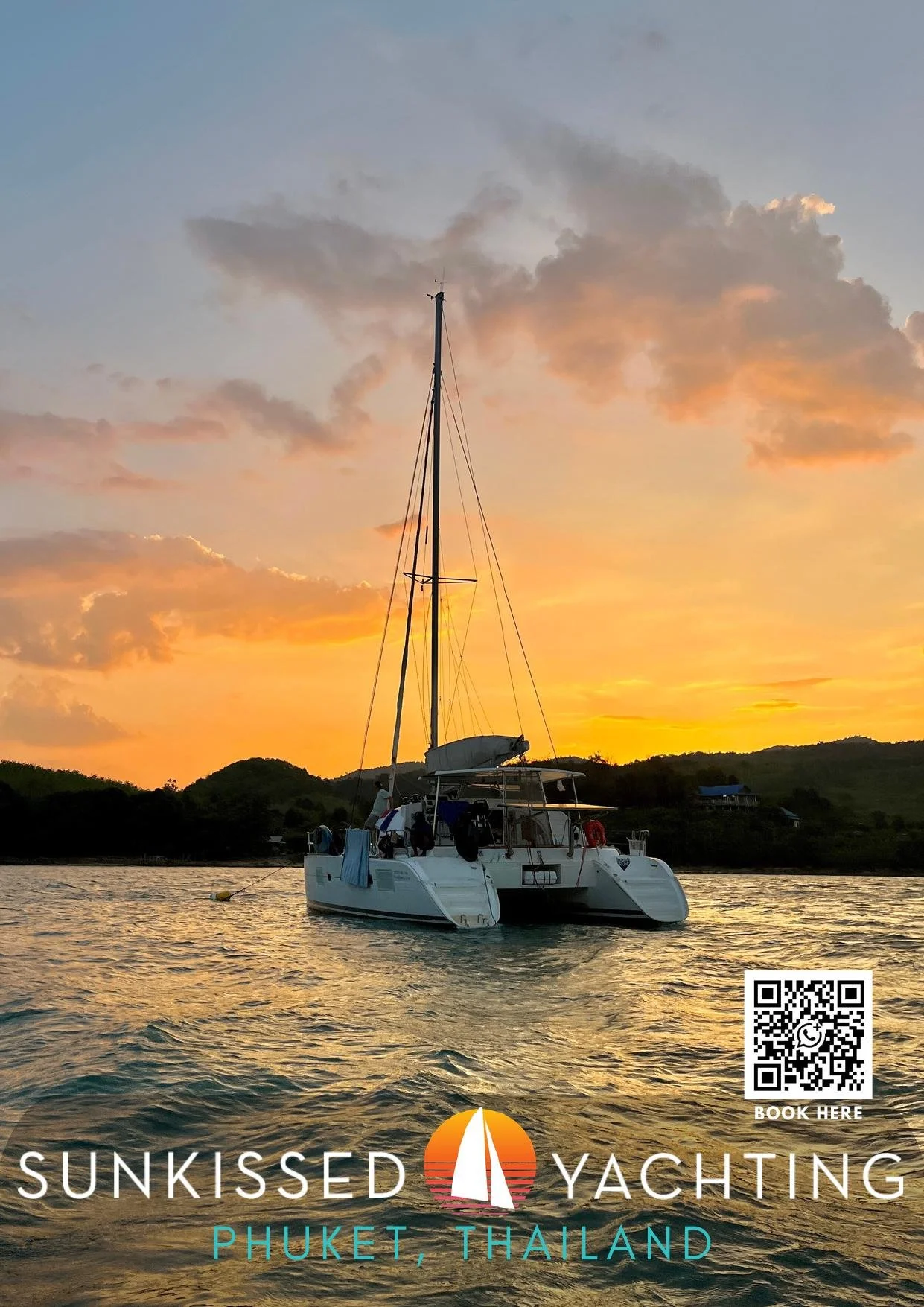 Catamaran anchored at golden sunset over Phuket bay with Sunkissed Yachting Phuket Thailand logo
