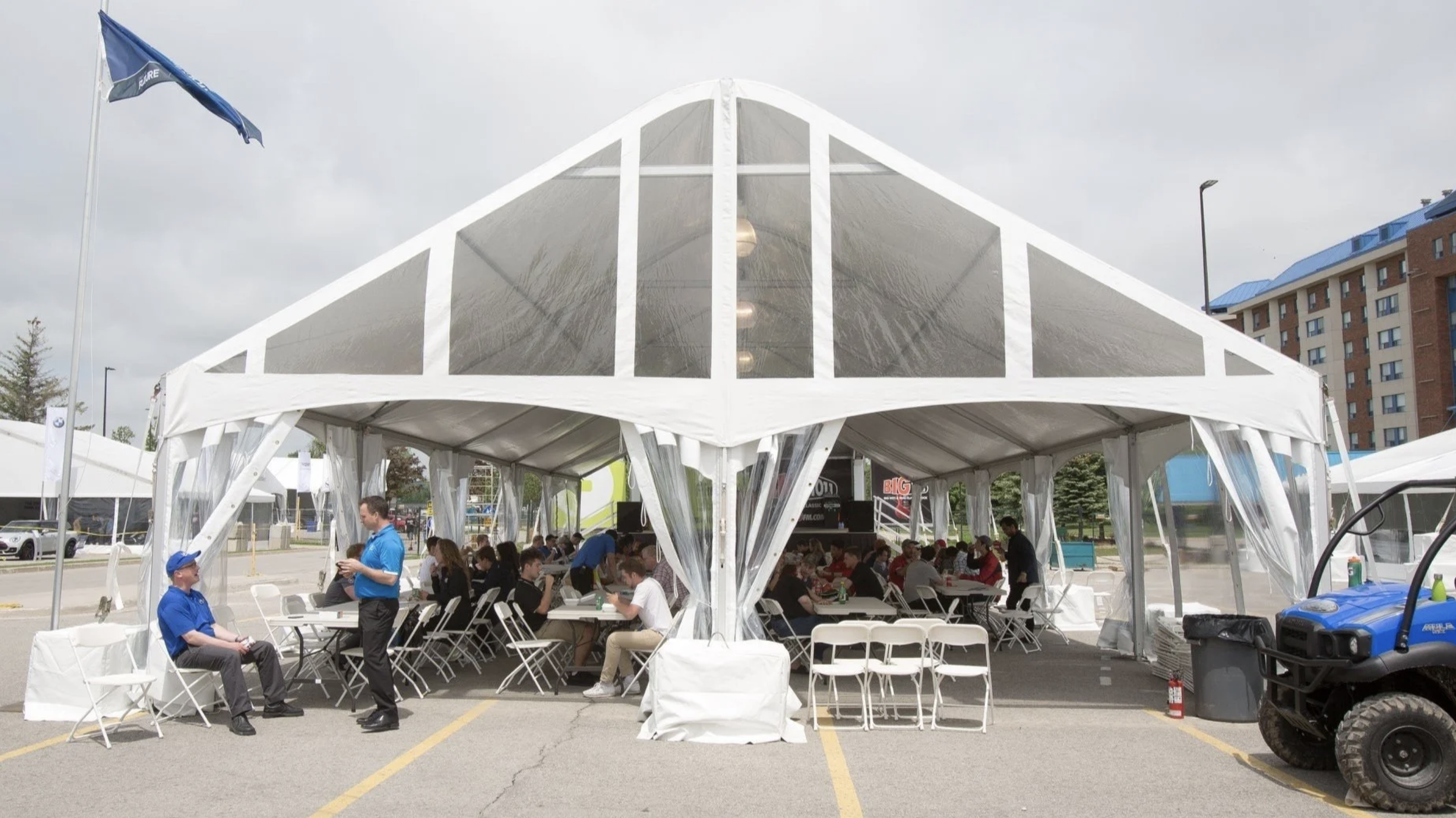 corporate outdoor event with tent tables and chairs