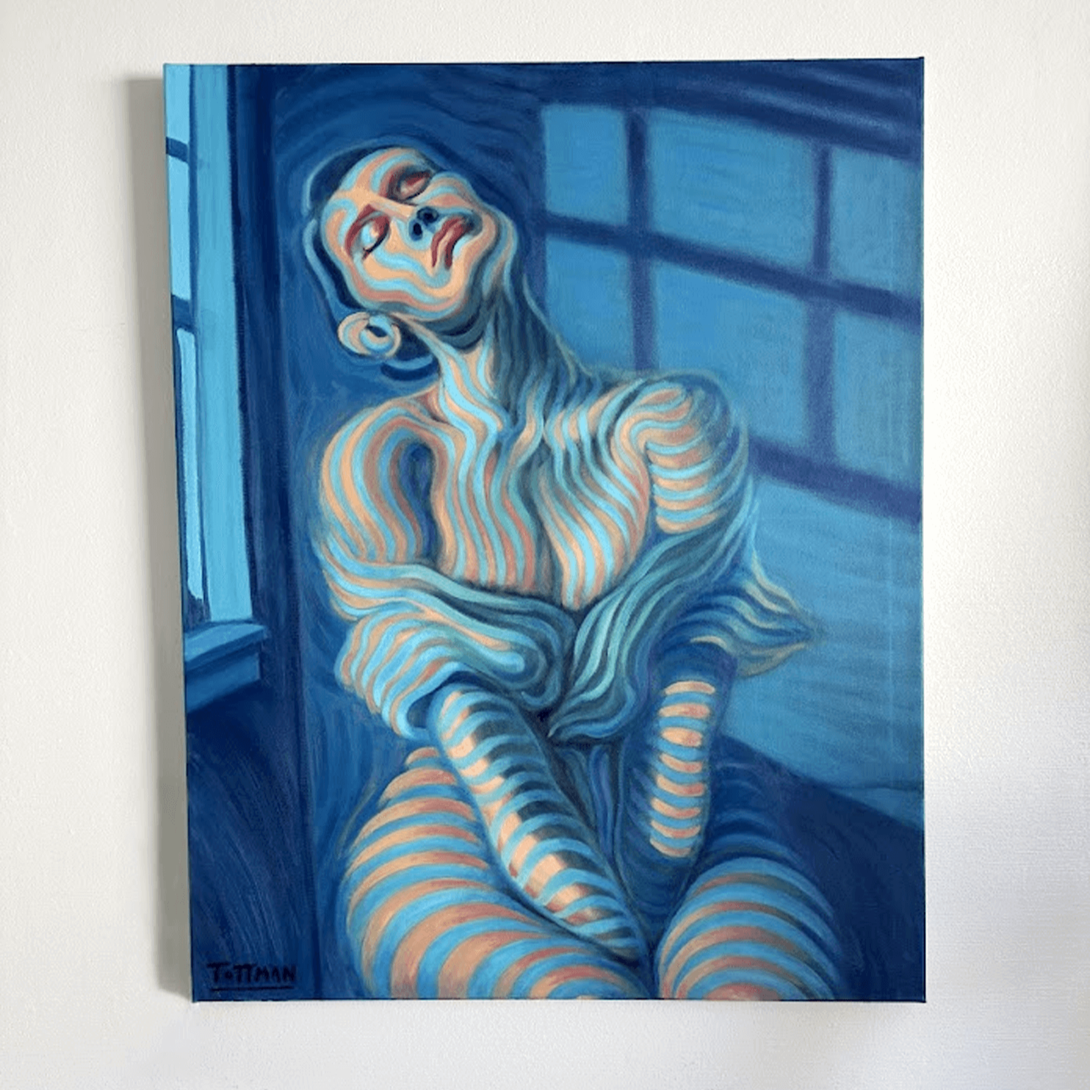 A painting of a woman with closed eyes, sitting with her knees pulled up, using bold blue and orange stripes against a blue background with window shadow patterns.
