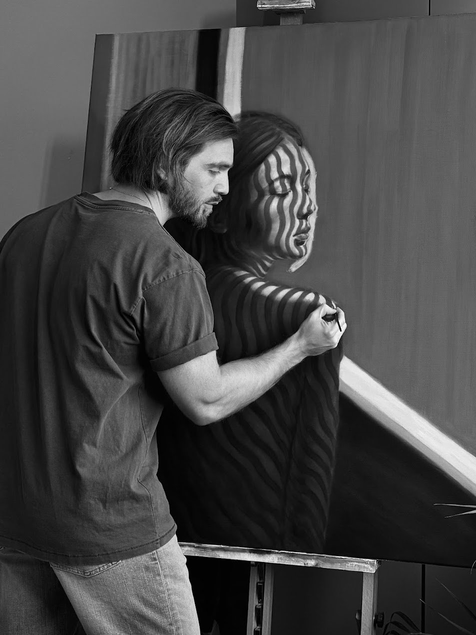 a man, james tottman, painting a woman with lines on her face