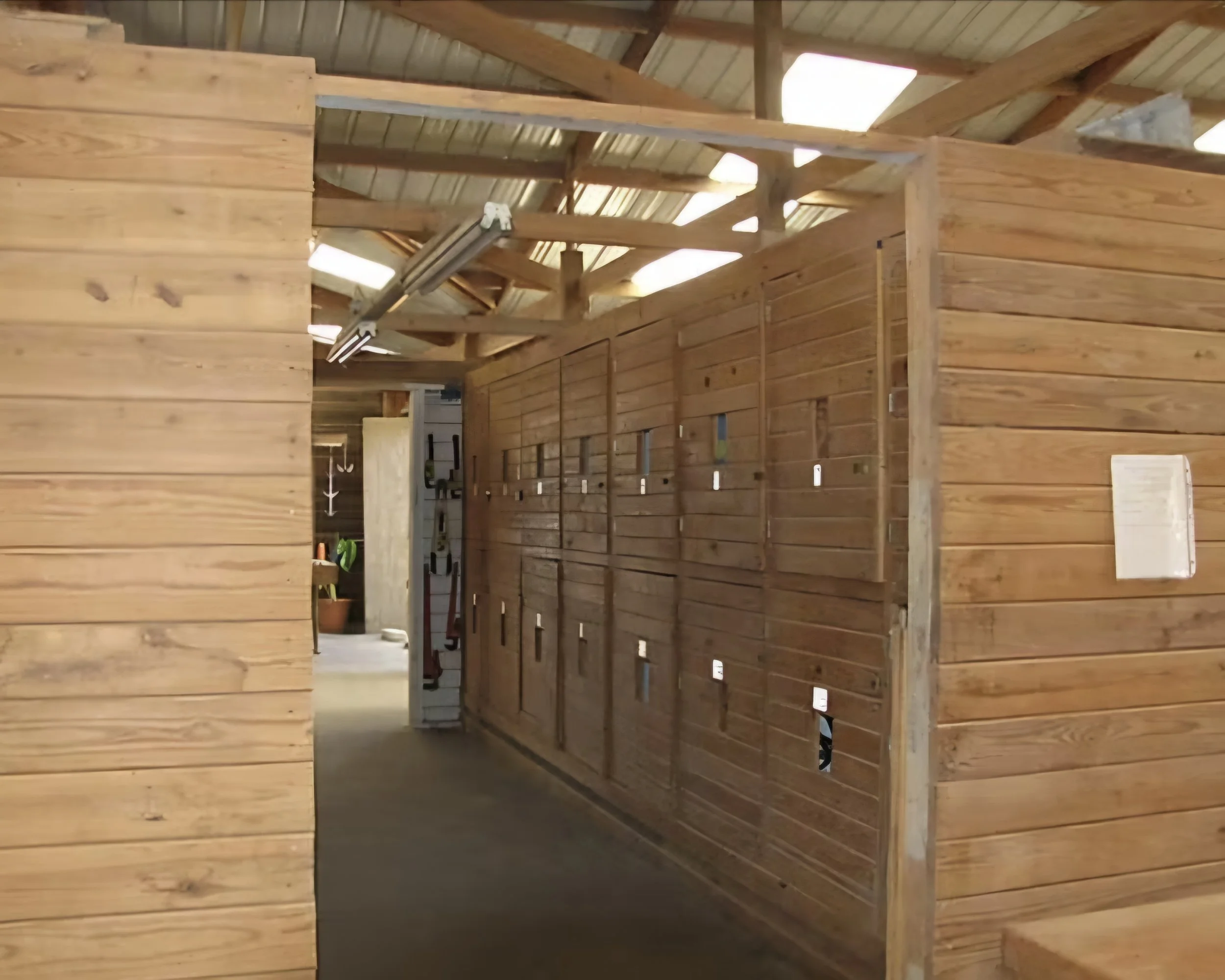 A wooden interior with tack lockers for boarders to keep their personal items