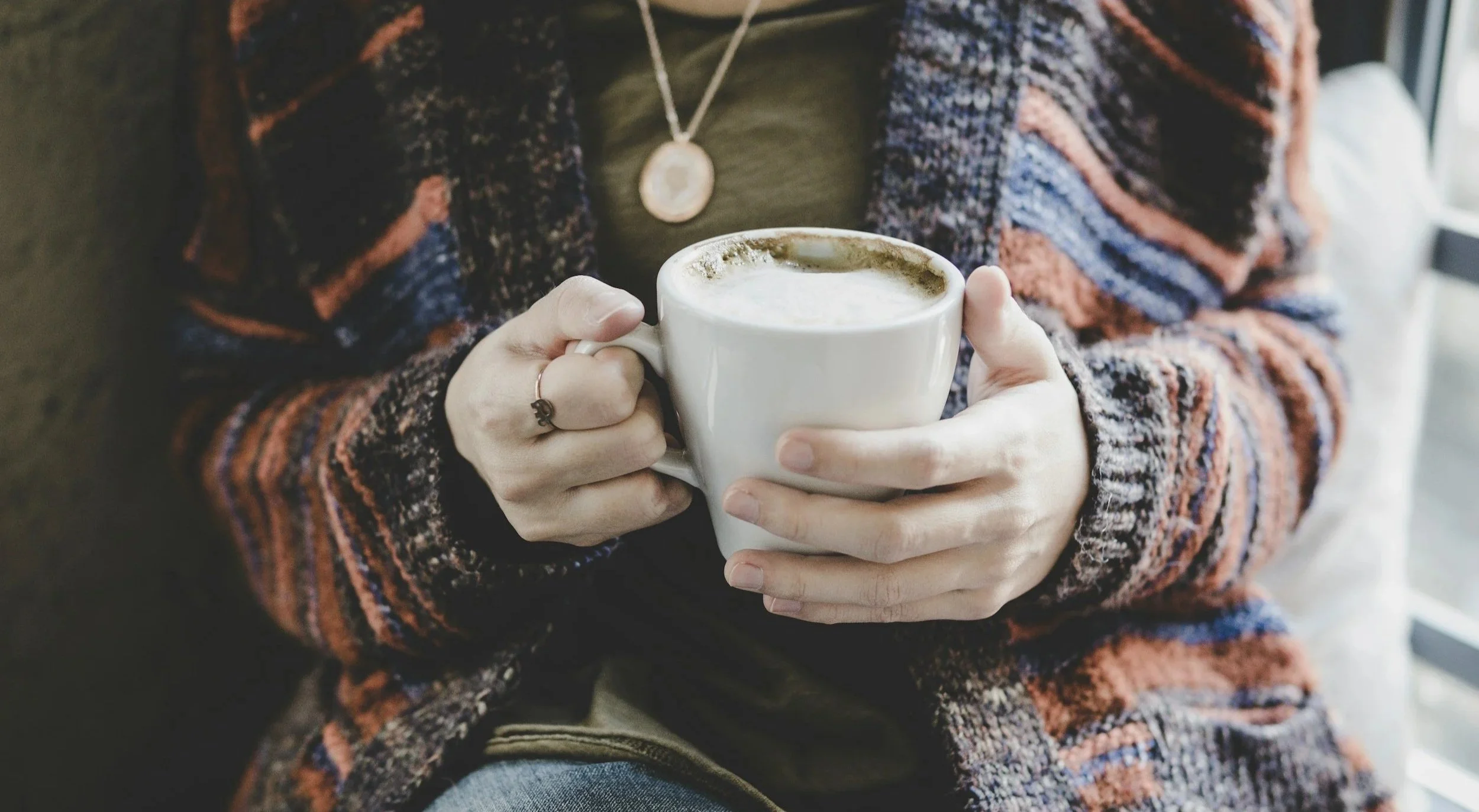 Woman's hands holding a morning coffee