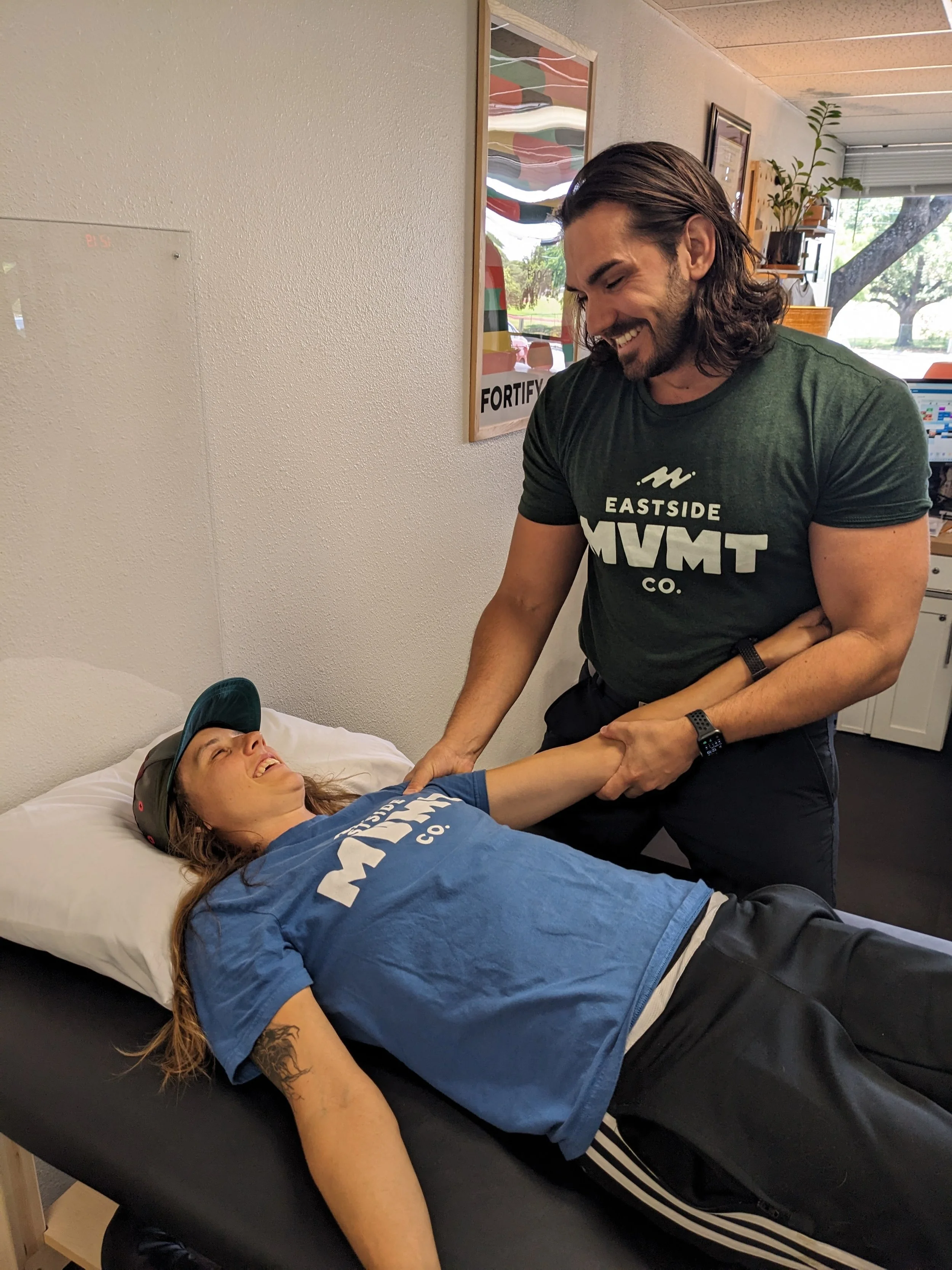 Physical therapist treating shoulder pain with manual therapy at Eastside Movement in Austin, TX.