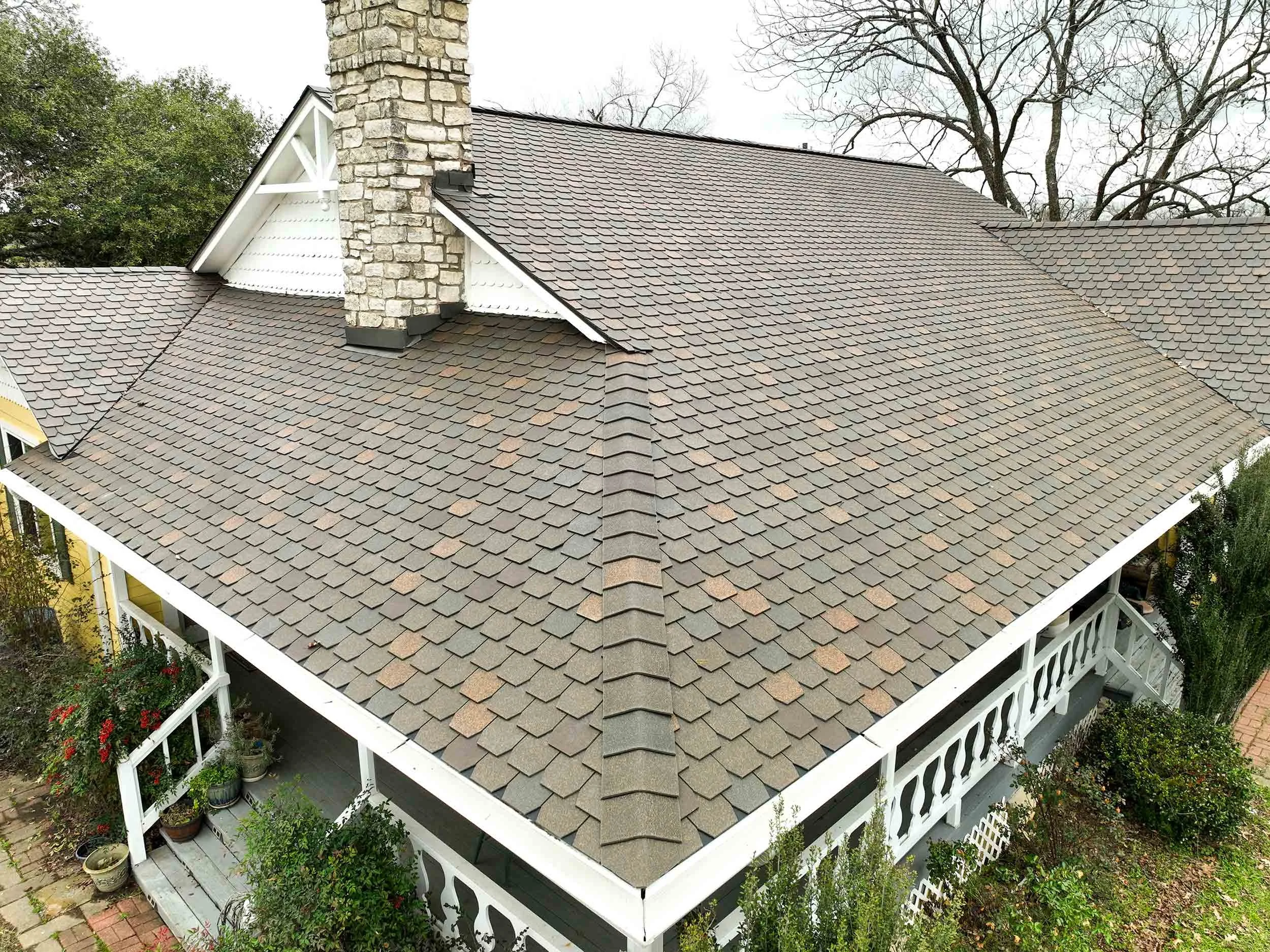A newly installed roof featuring synthetic F-Wave roofing shingles near Elgin, Texas. Installed by Roofing Turtle.