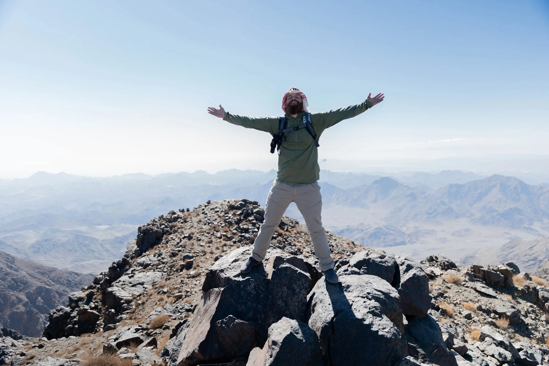 Will Andrew Smith of Snazzy Travel standing on the peak of Jabal Maqla in Saudi Arabia.