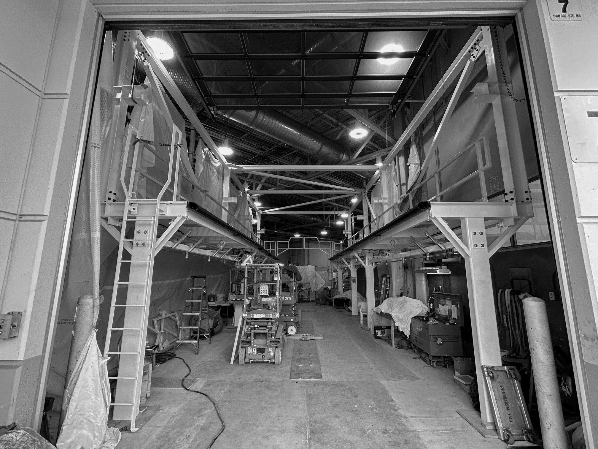Bus Bay 7 with mezzanine service platforms under installation inside a maintenance shop