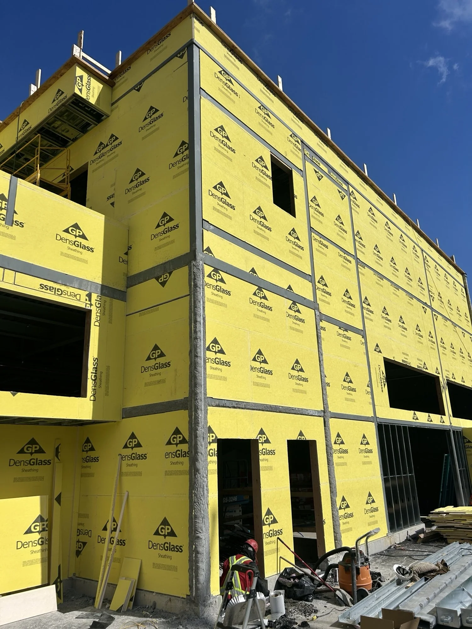 Exterior walls clad with GP DensGlass sheathing during commercial building envelope construction