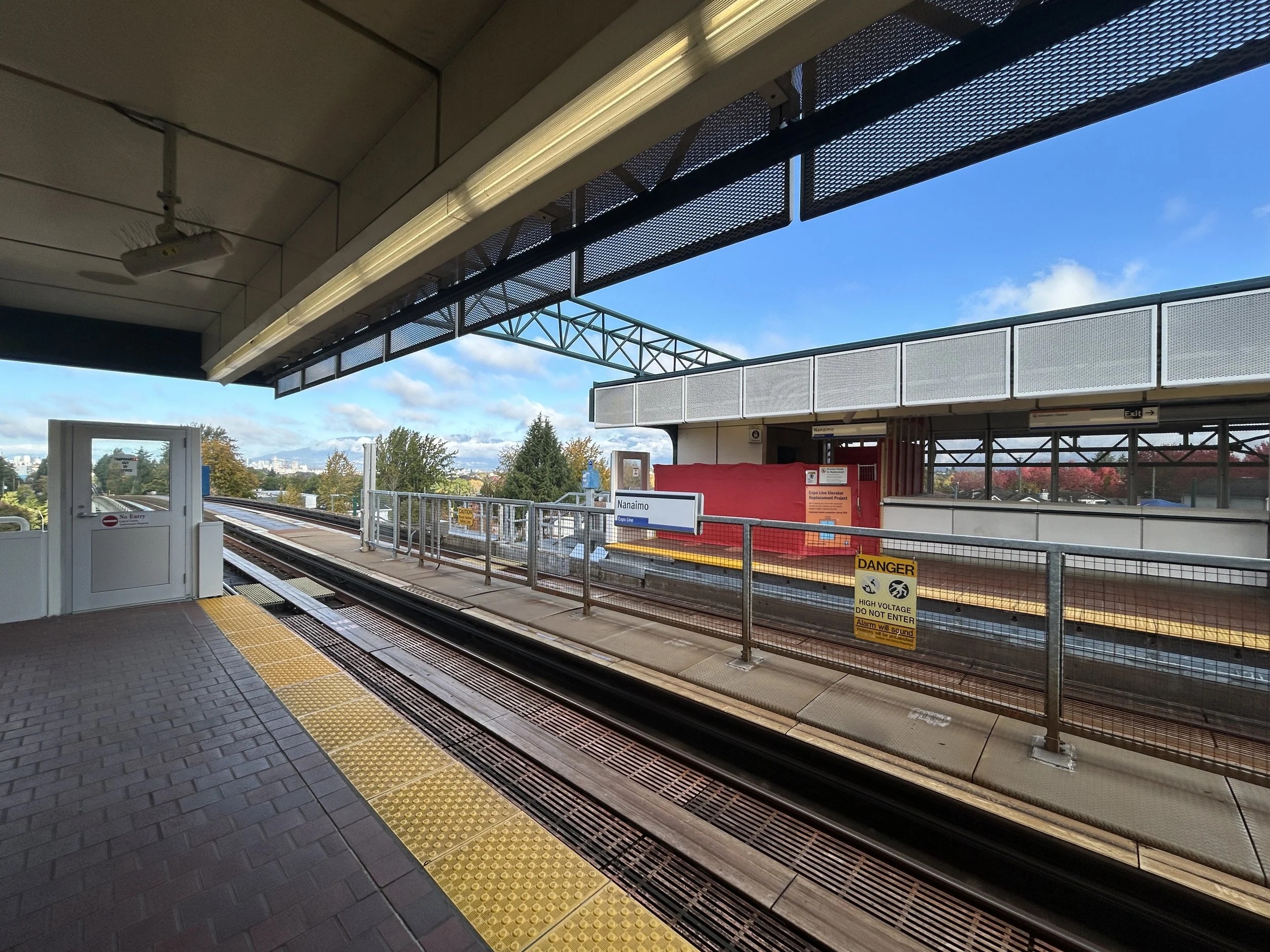 Wide view of Nanaimo SkyTrain platform with tactile safety edging and hoarding during upgrades