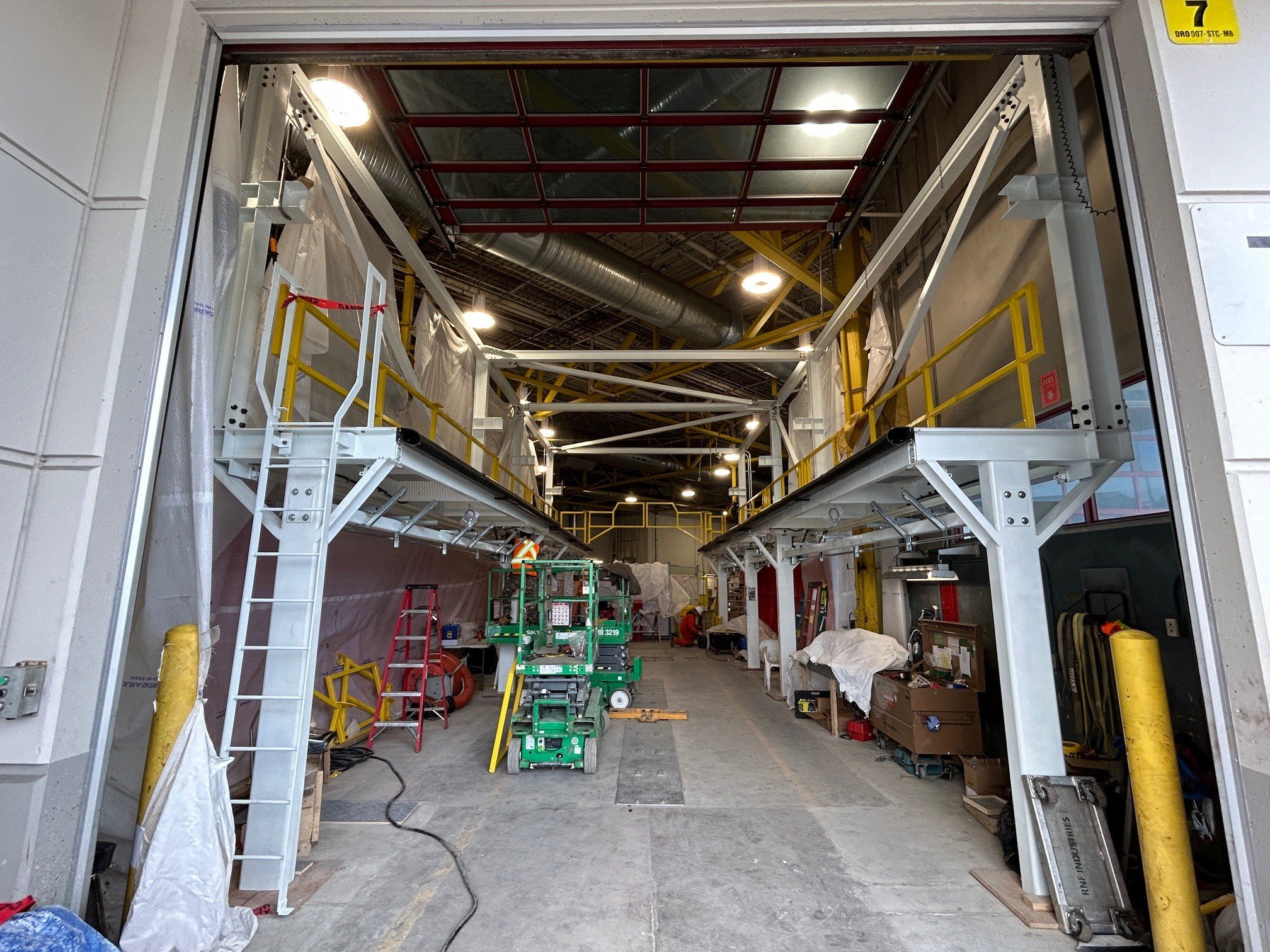 Bus Bay 7 with mezzanine service platforms under installation inside a maintenance shop