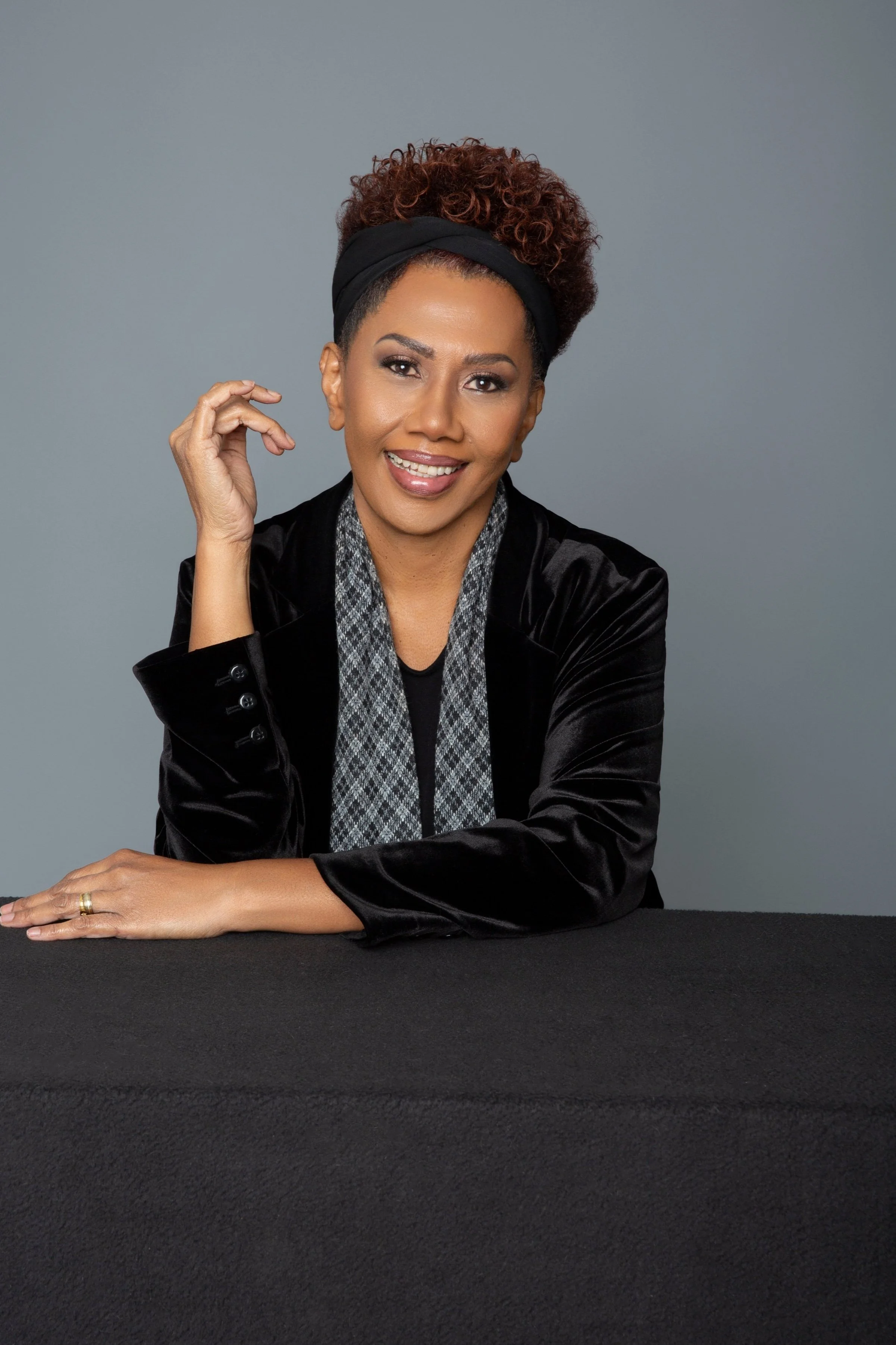 african american woman sitting black blazer