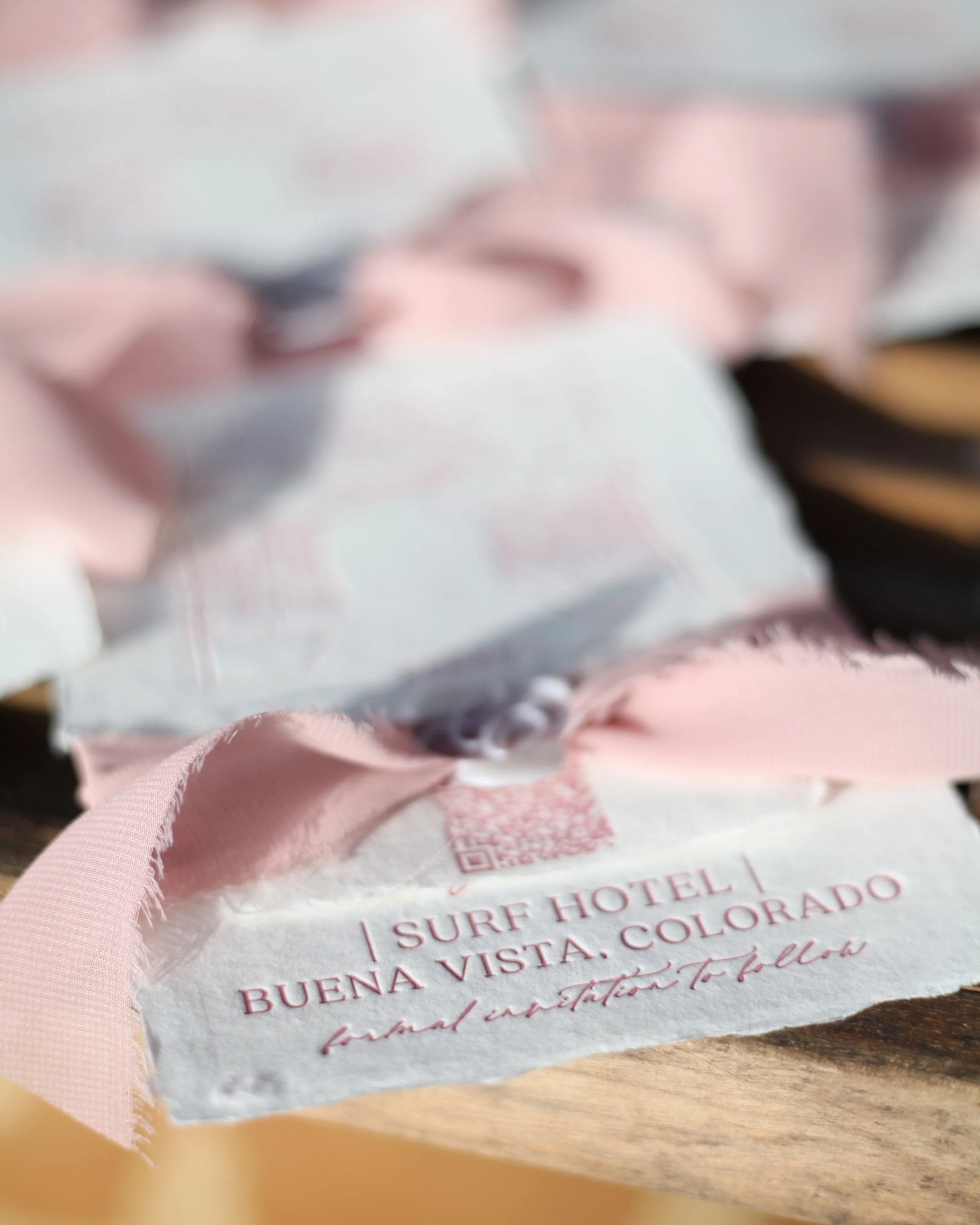 Save the Date on handmade paper featuring custom couples monogram wax seal and silk chiffon ribbon