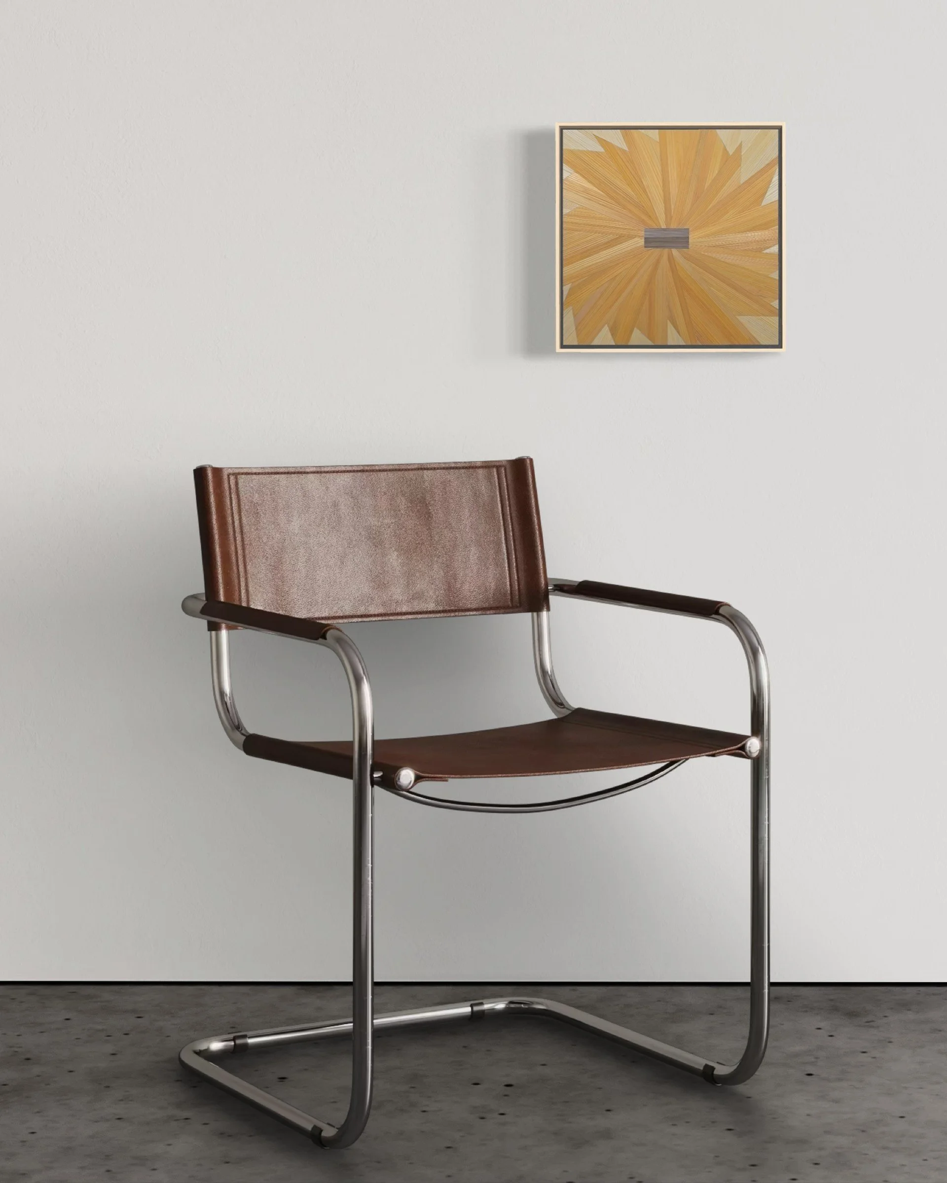 Straw marquetry panel in a pinwheel composition of golden yellow mounted on a white wall above a modern chair; small-format contemporary fiber art in an interior setting