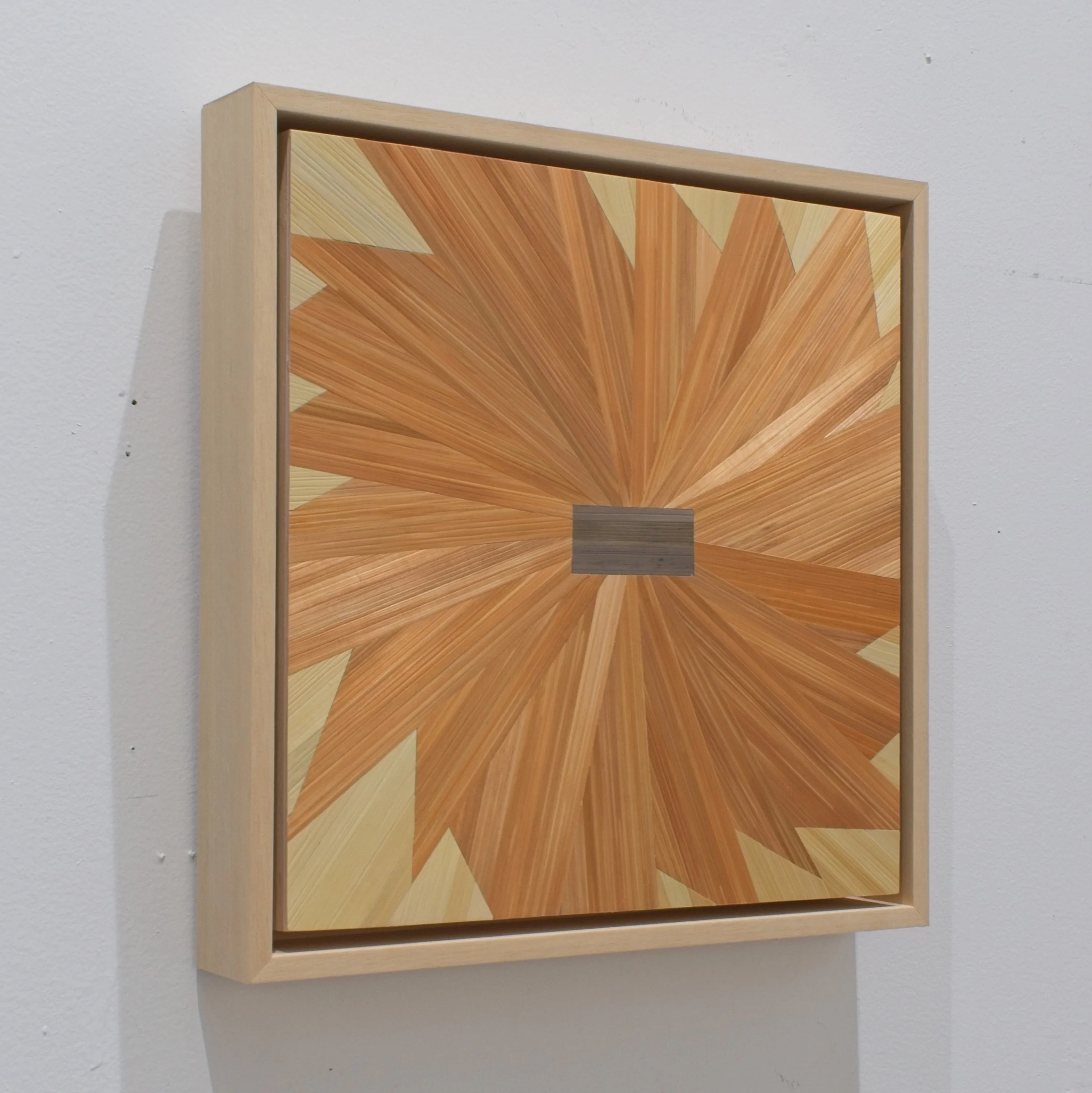 Side profile of a float-framed straw marquetry panel showing maple frame depth; small-format contemporary fiber art on wood panel