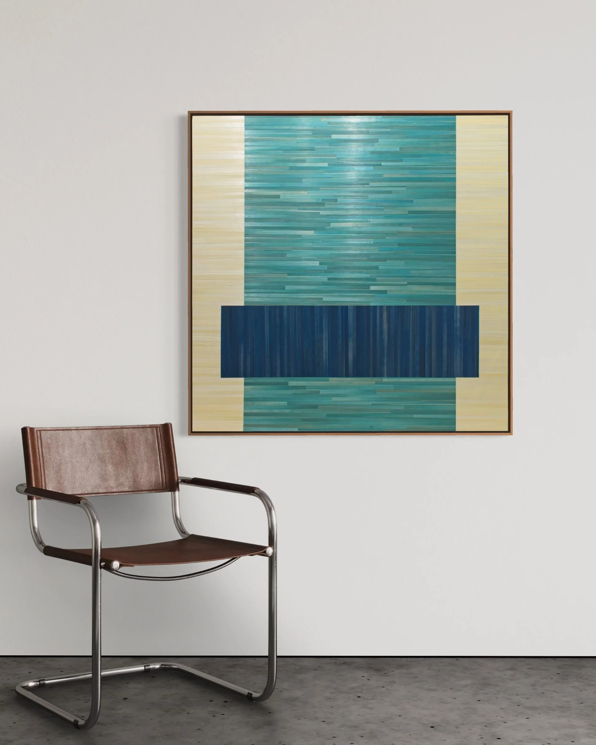 Contemporary abstract artwork made from straw shown hanging above a modern chair. Bold and geometric in teal and blue.