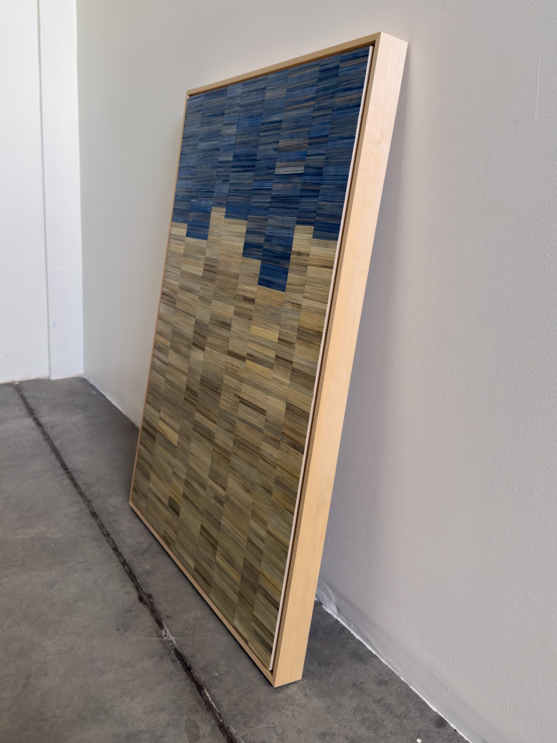 Side view of 'The Weight of Air' framed, capturing the dimensional quality of the straw marquetry. Made in Boston.