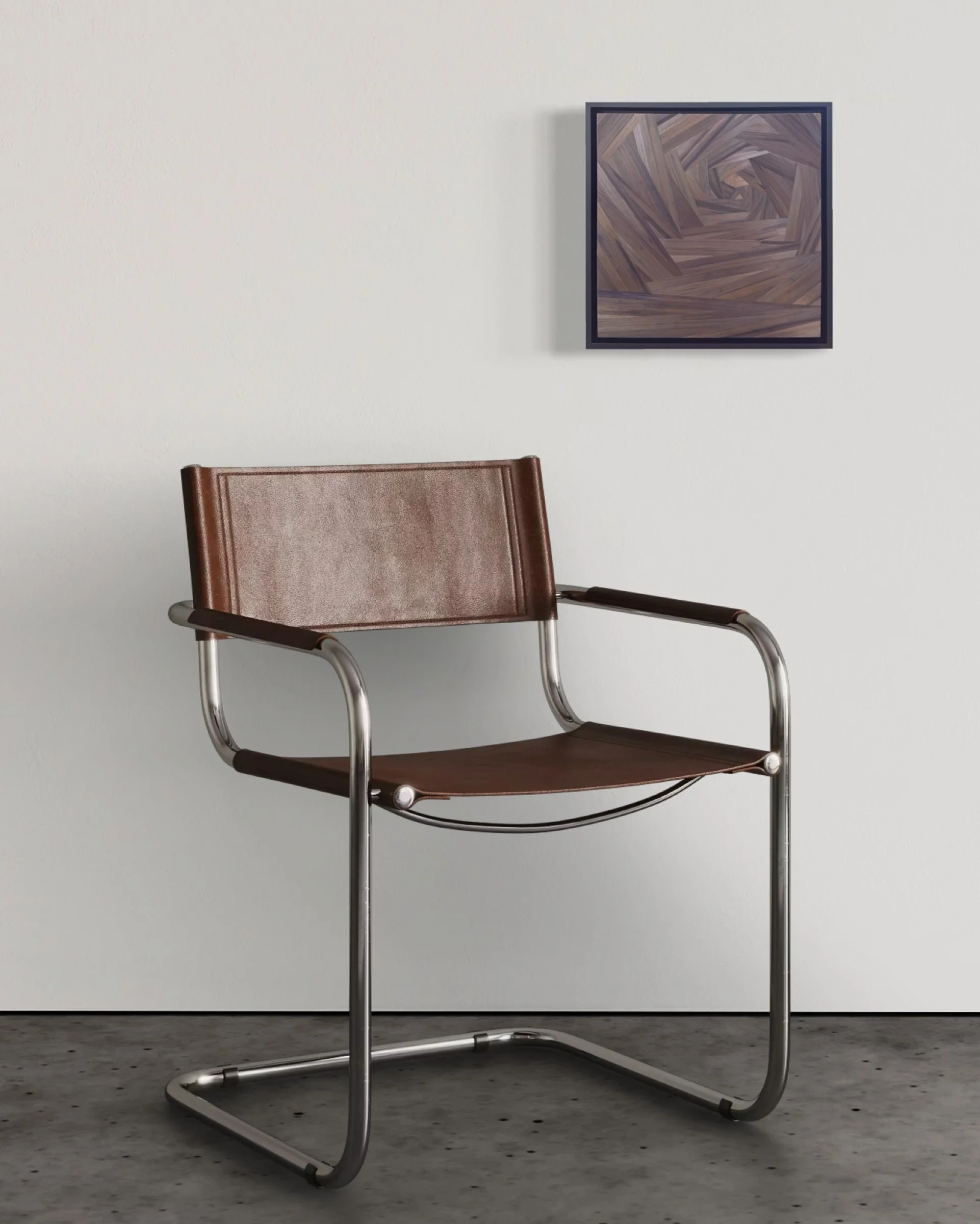 Small-scale straw marquetry panel in black float frame mounted on a plain white wall above a modern chair, showing work at 12 × 12 inches in an interior setting