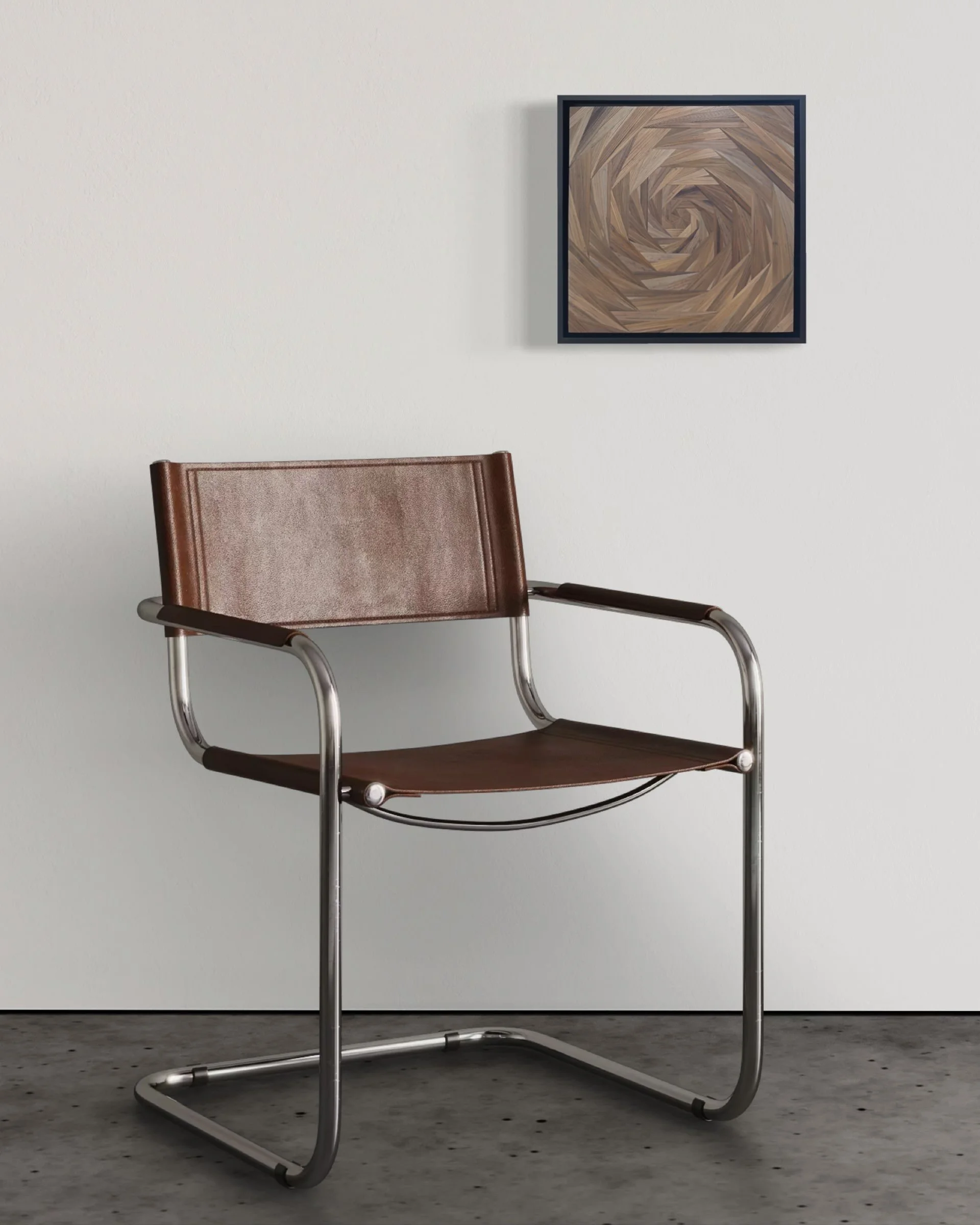 Small-scale straw marquetry panel in black float frame mounted on a plain white wall above a modern chair, showing work at 12 × 12 inches in an interior setting