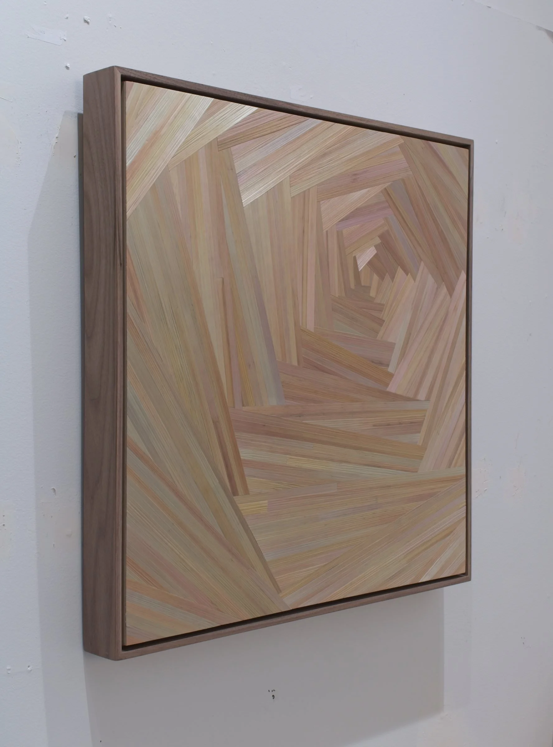 Side profile of float-framed straw marquetry panel showing walnut frame depth and the iridescent surface quality of the rye straw