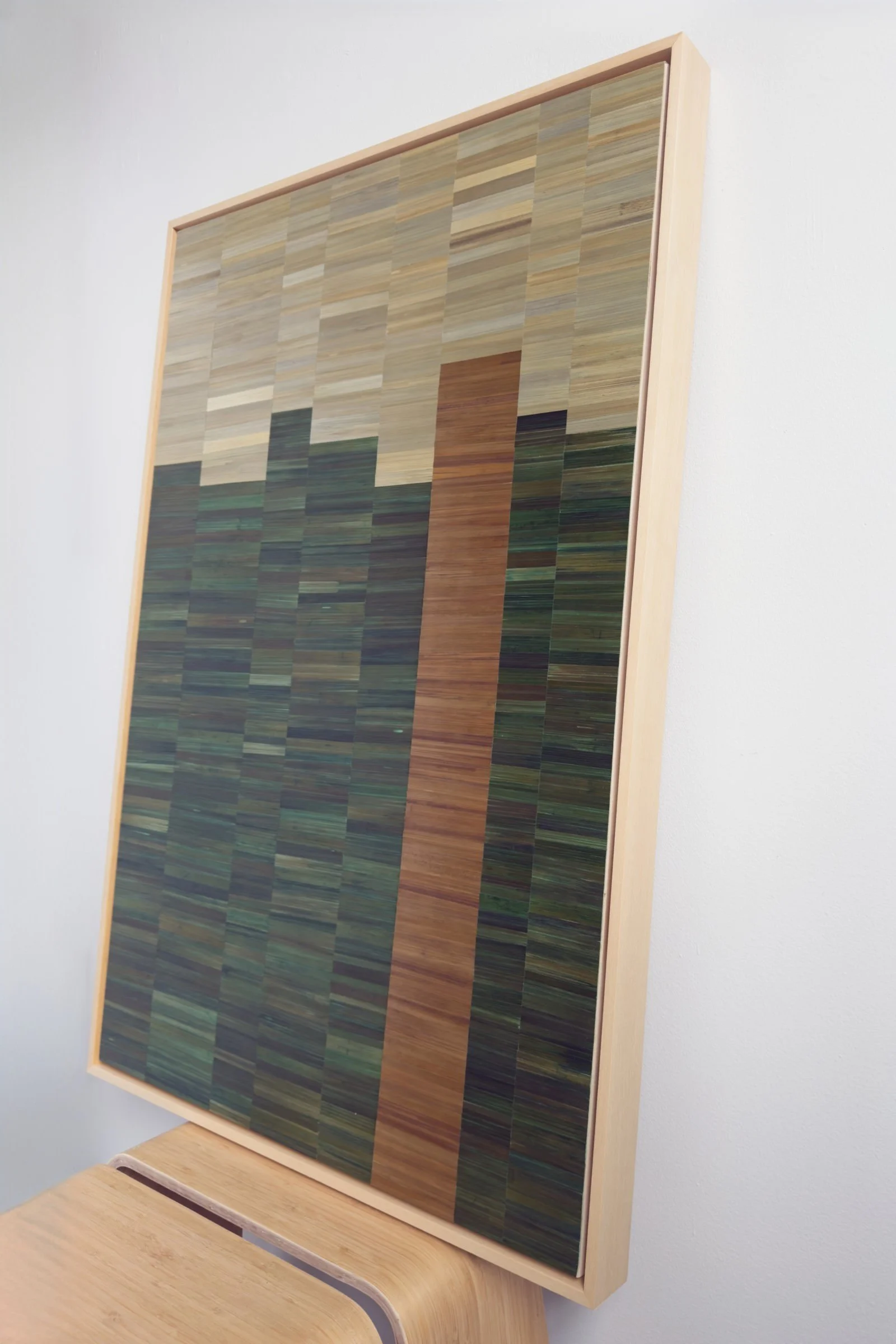 Side view of a float-framed straw marquetry panel showing depth of maple frame and straw surface texture. Palette of green, gold, and beige, 36x24in