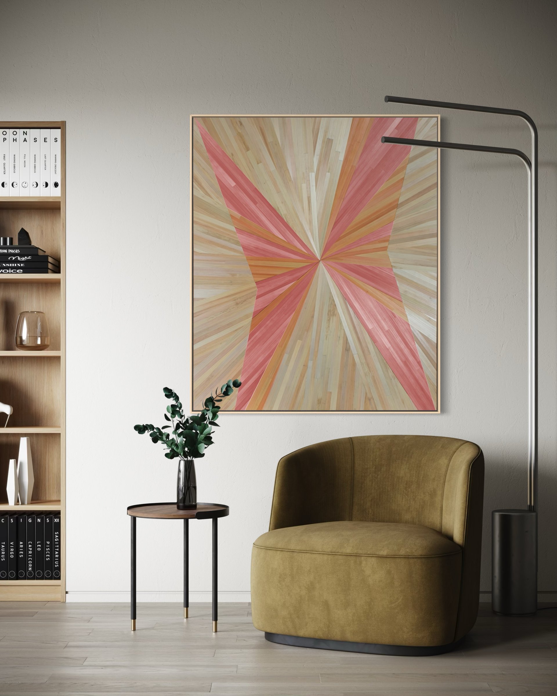An asymmetrical straw marquetry artwork in cream, pink, and light orange tones, forming a subtle, butterfly-like motif. Displayed in a contemporary library sitting area, this luminous piece adds a sense of movement and subtle whimsy. Its warm palette