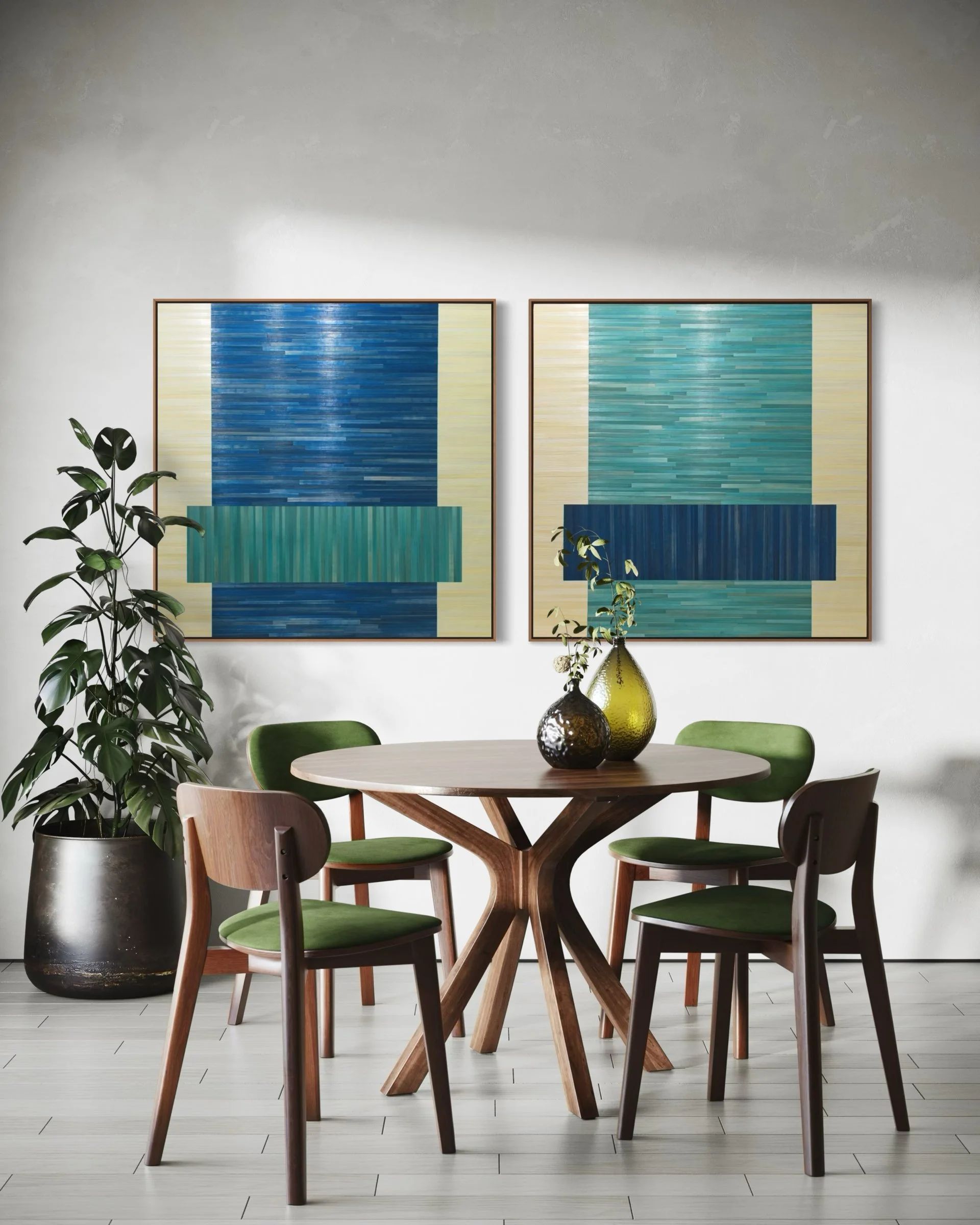 A pair of contemporary abstract geometric straw marquetry artworks in a color block composition, featuring a palette of cream, teal, and navy blue. Float framed in walnut and hung side-by-side in a contemporary dining area, these pieces add bold text
