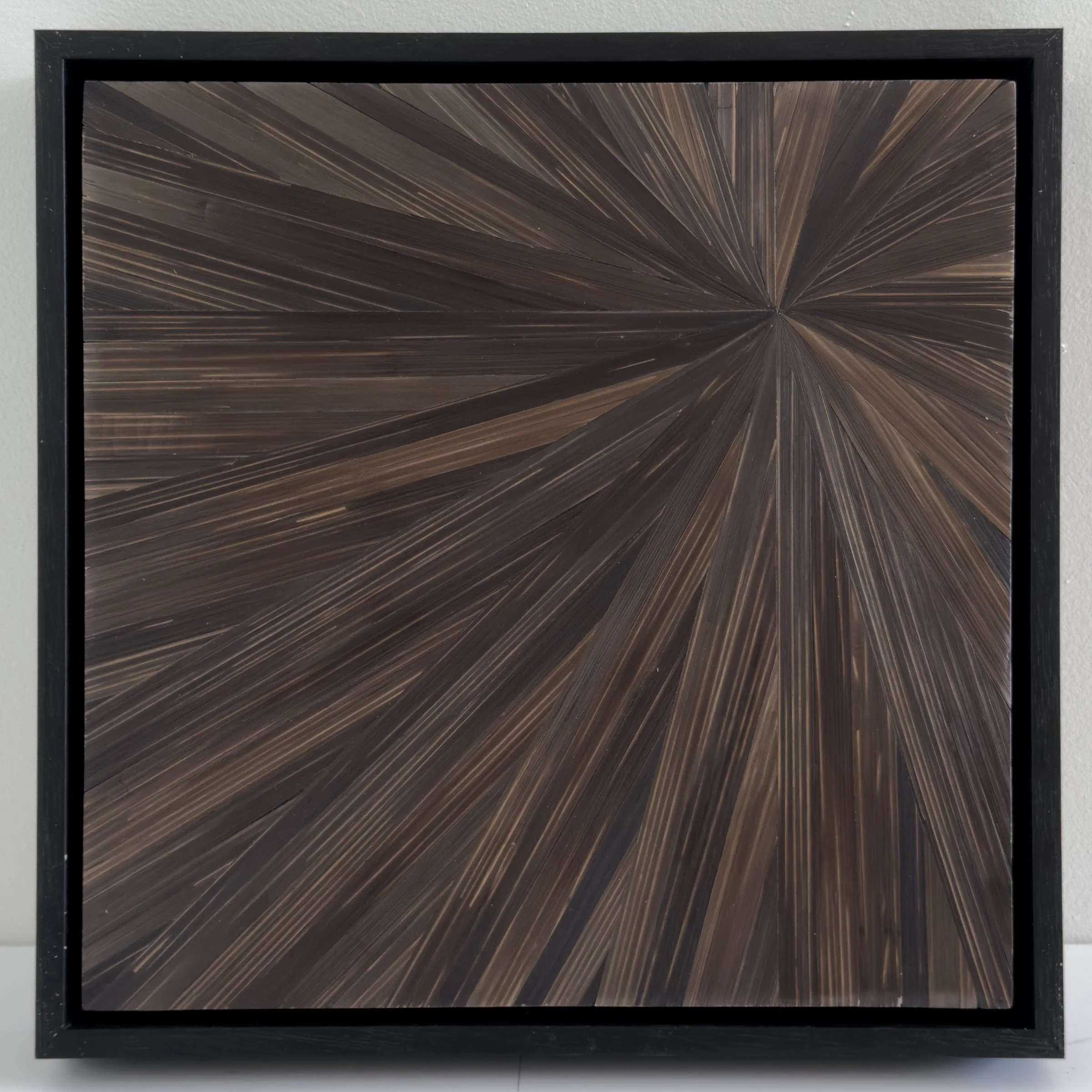 Straw marquetry contemporary abstract art shown in a brown radial pattern, 12in x 12in.