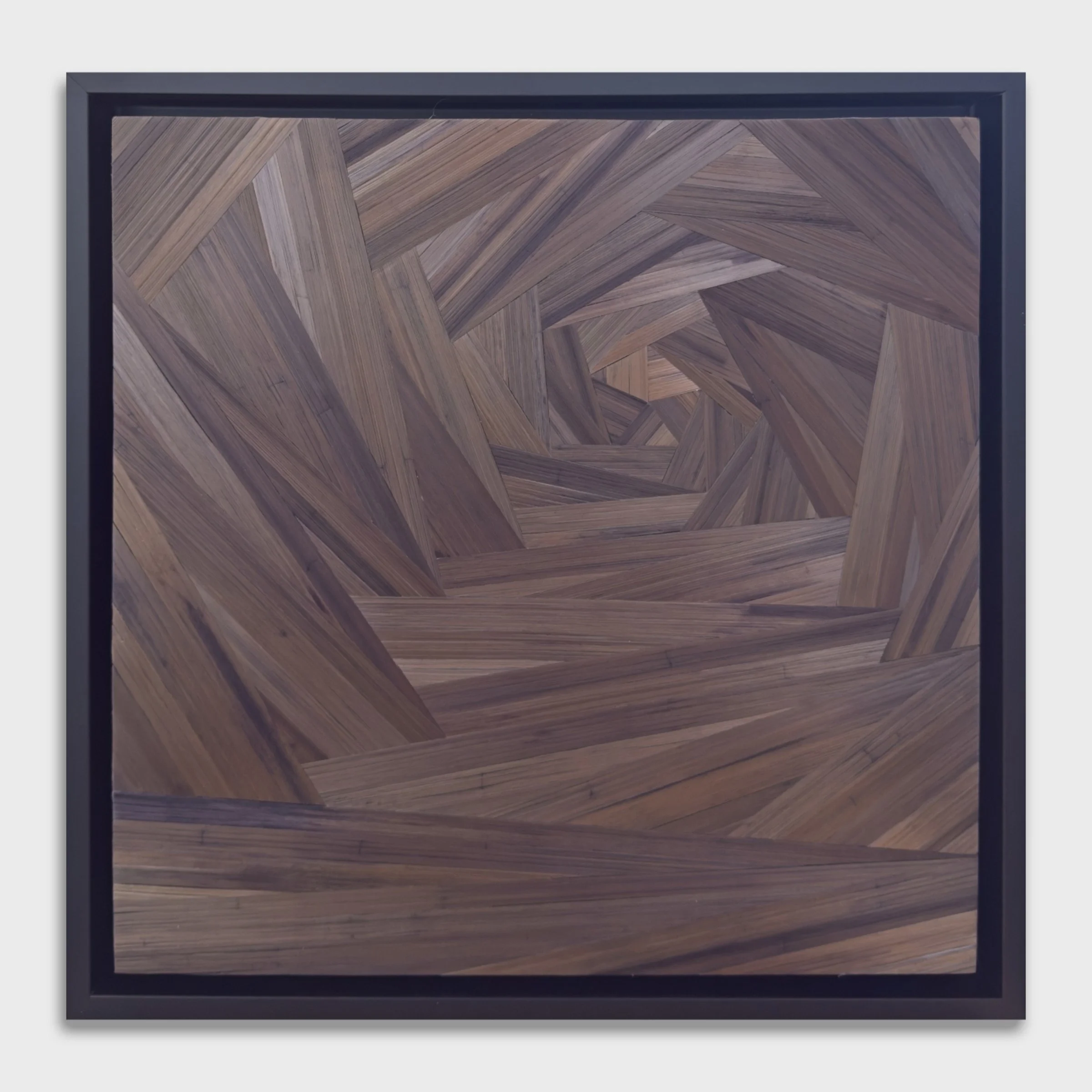 Straw marquetry wall panel, asymmetrical pentagon spiral in deep cool brown rye straw on wood, in a black float frame, 12 × 12 inches