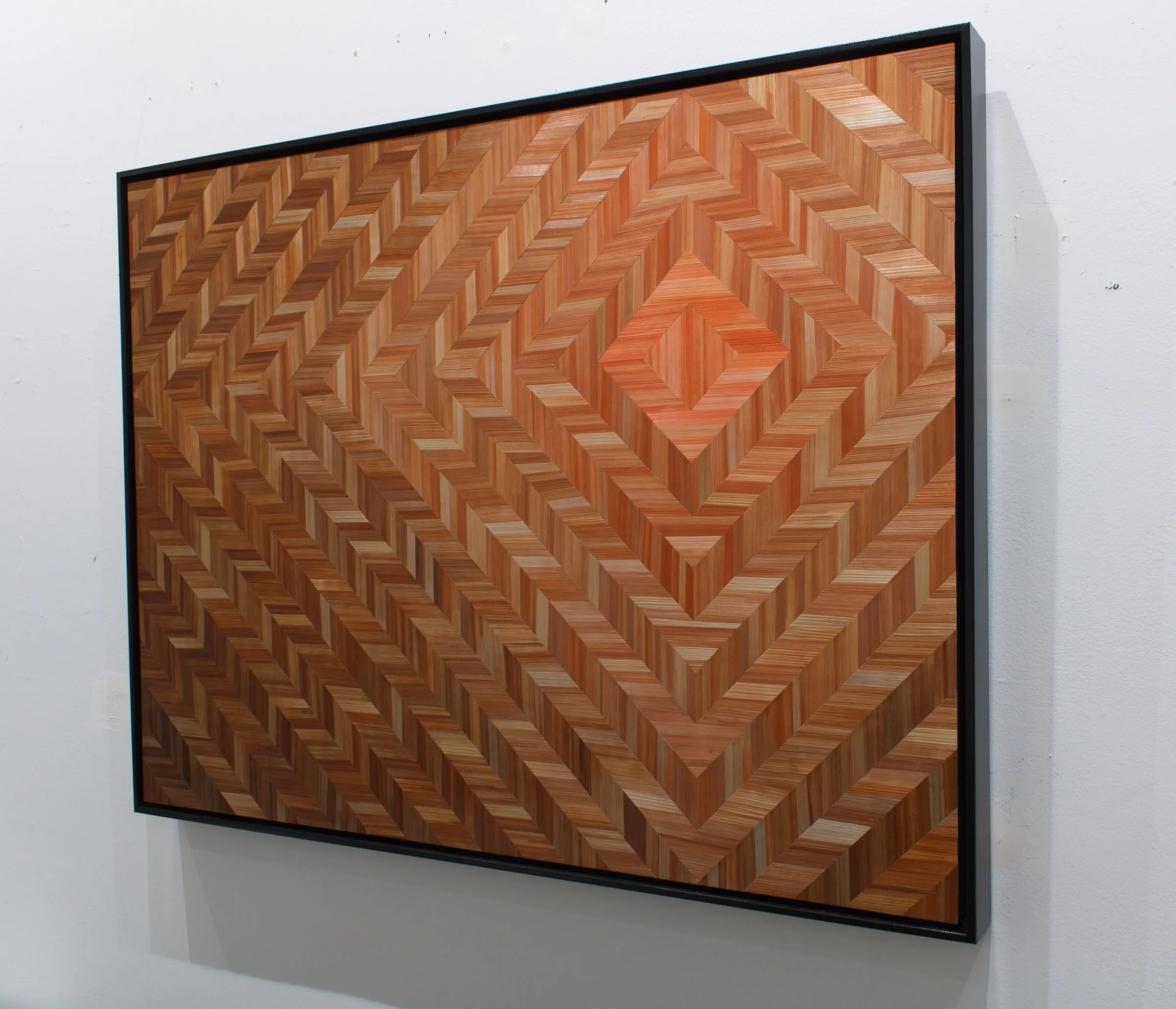 Side profile of float-framed straw marquetry panel showing depth of black frame and luminous straw surface