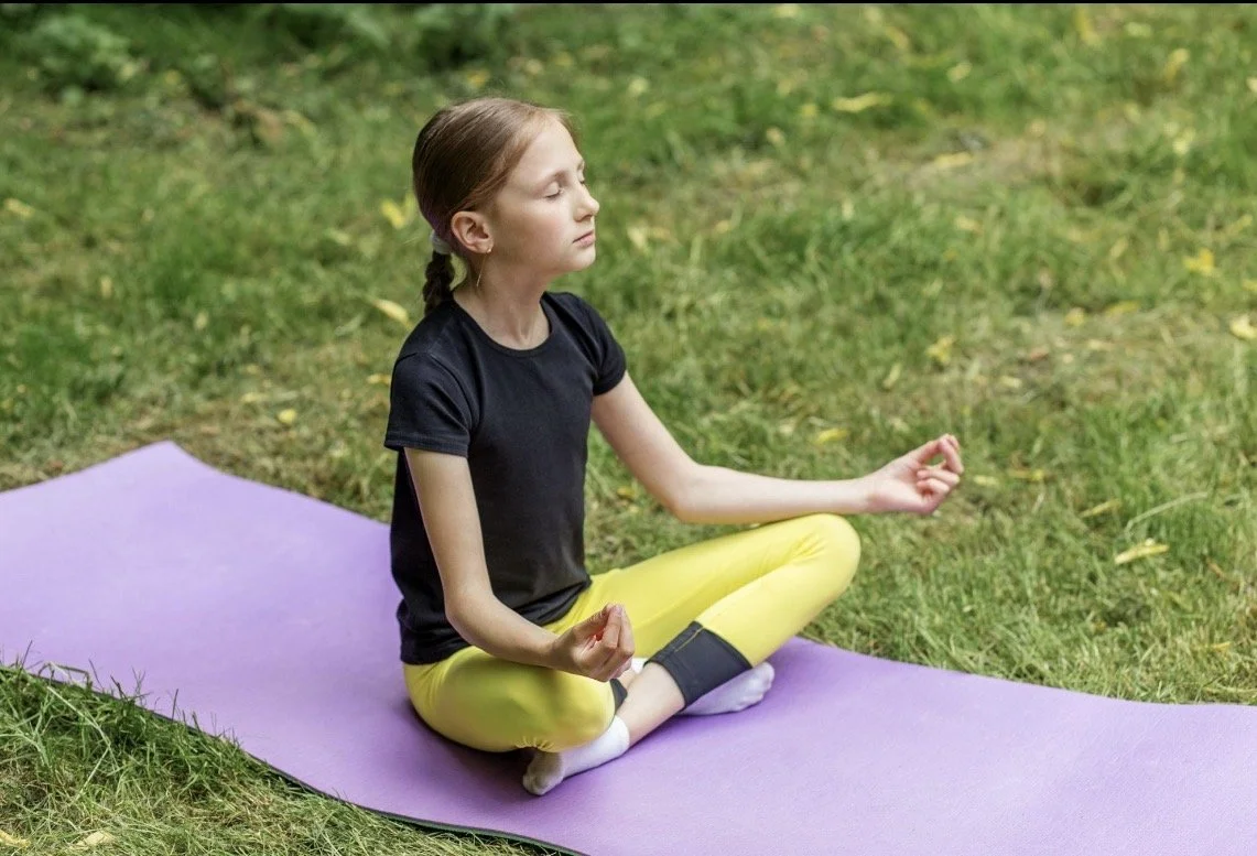 Child on a yoga mat