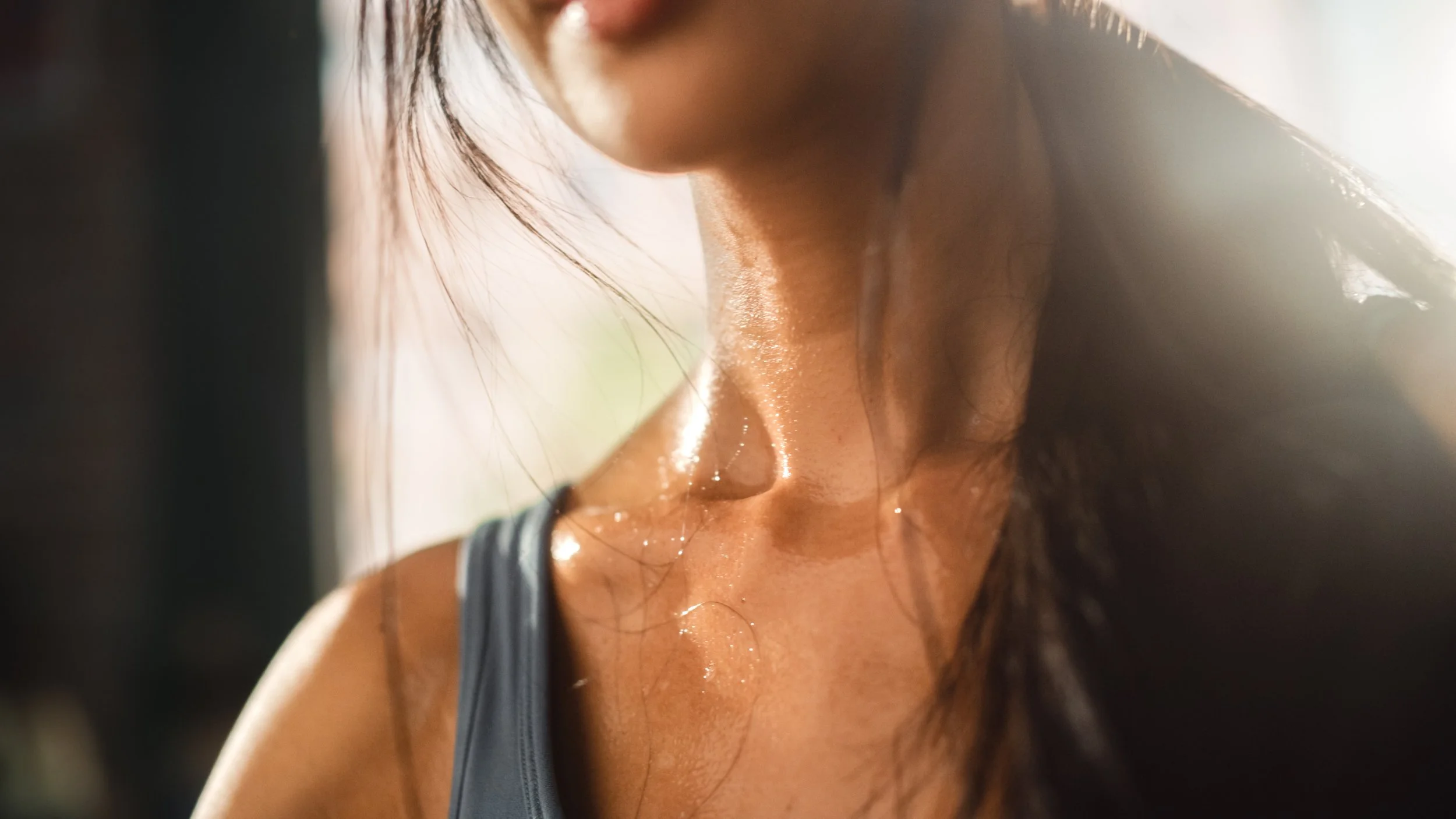 Woman with sweat on collar bones