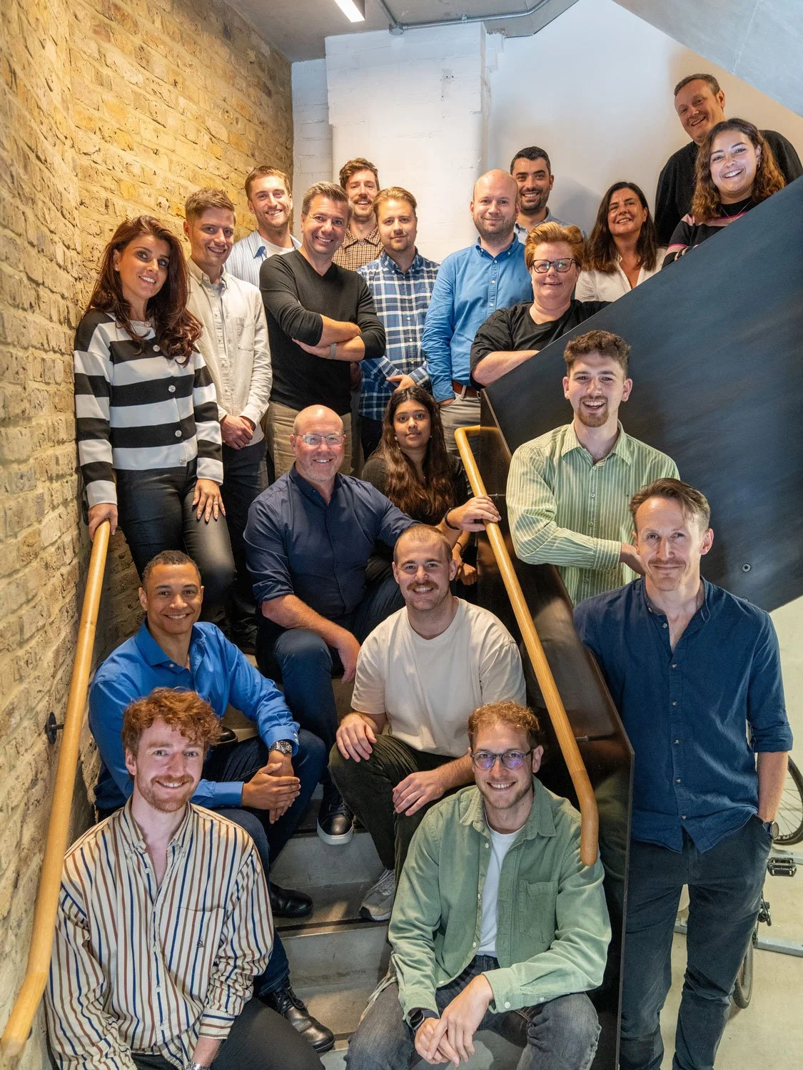 Group photo of the Form Structural Design team gathered on a staircase at the office.