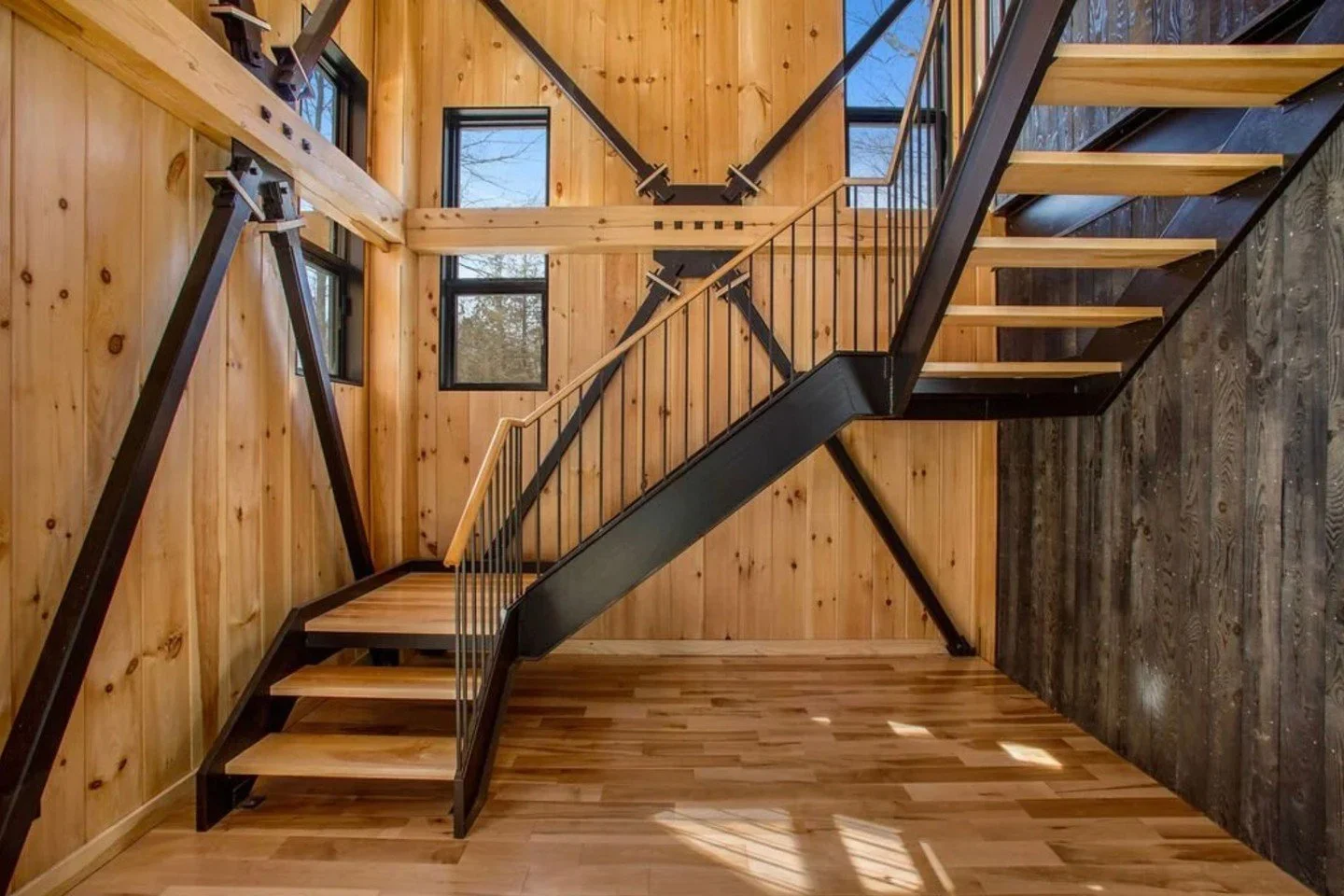 This stunning lakeside residence features extensive custom steel elements, especially in the staircase design. The architectural vision was crafted by Tim Duffy. Collaborating with Winter Wood Timberframes, we brought this unique timber frame project