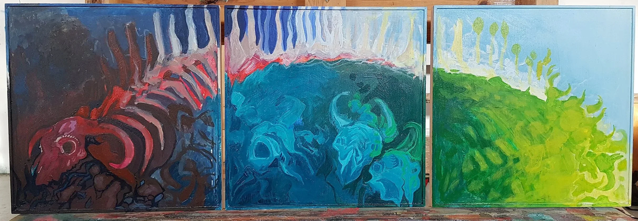 Triptych abstract paintings with skulls and face profiles in vibrant colors.