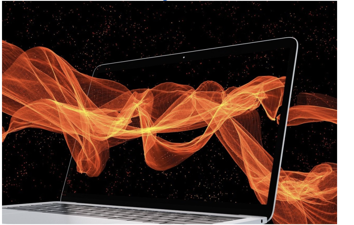 A laptop computer with a black screen displaying swirling orange digital waves against a black background with small red dots.