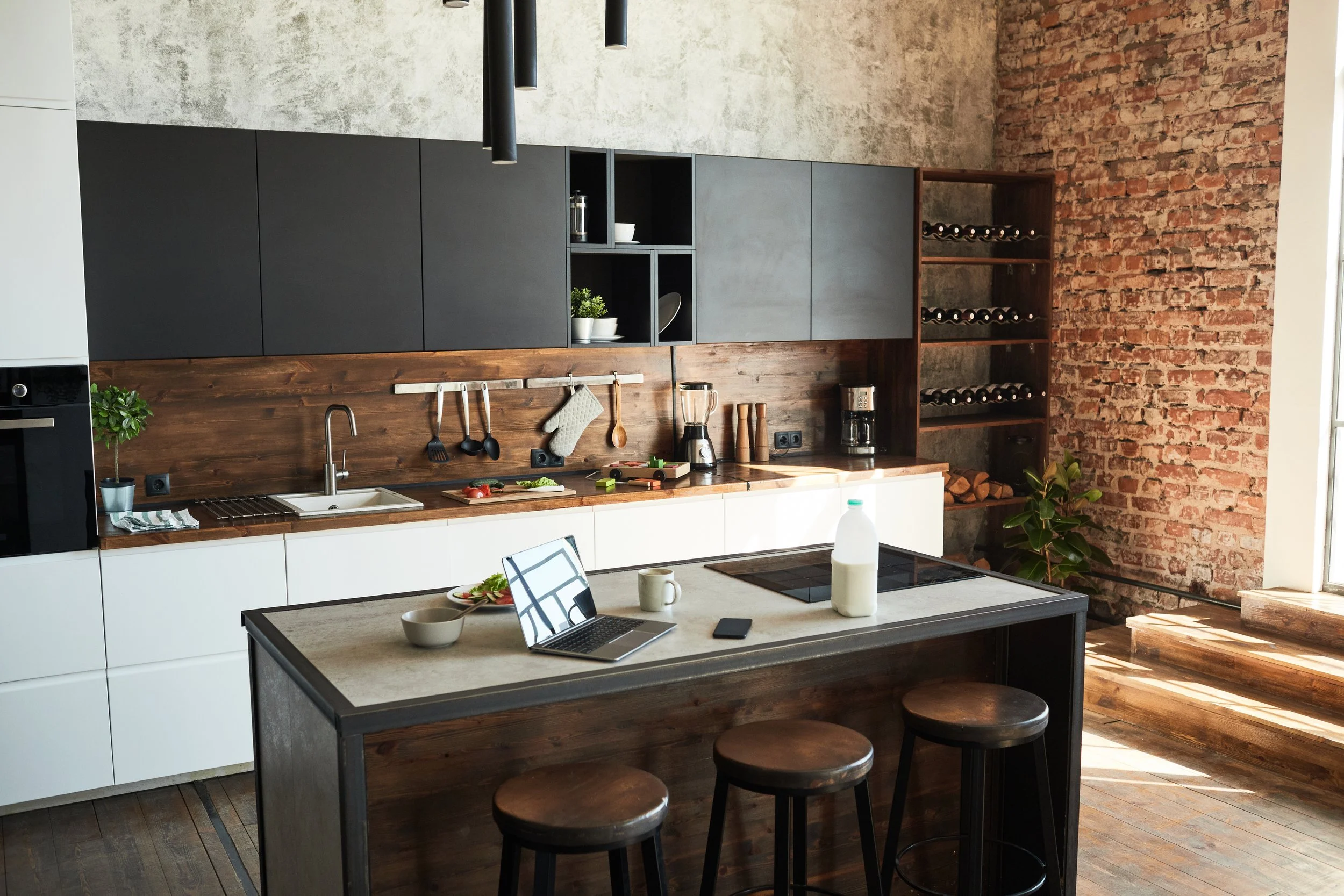 Rustic custom-designed kitchen with brick wall feature, wooden backsplash, and wine rack.