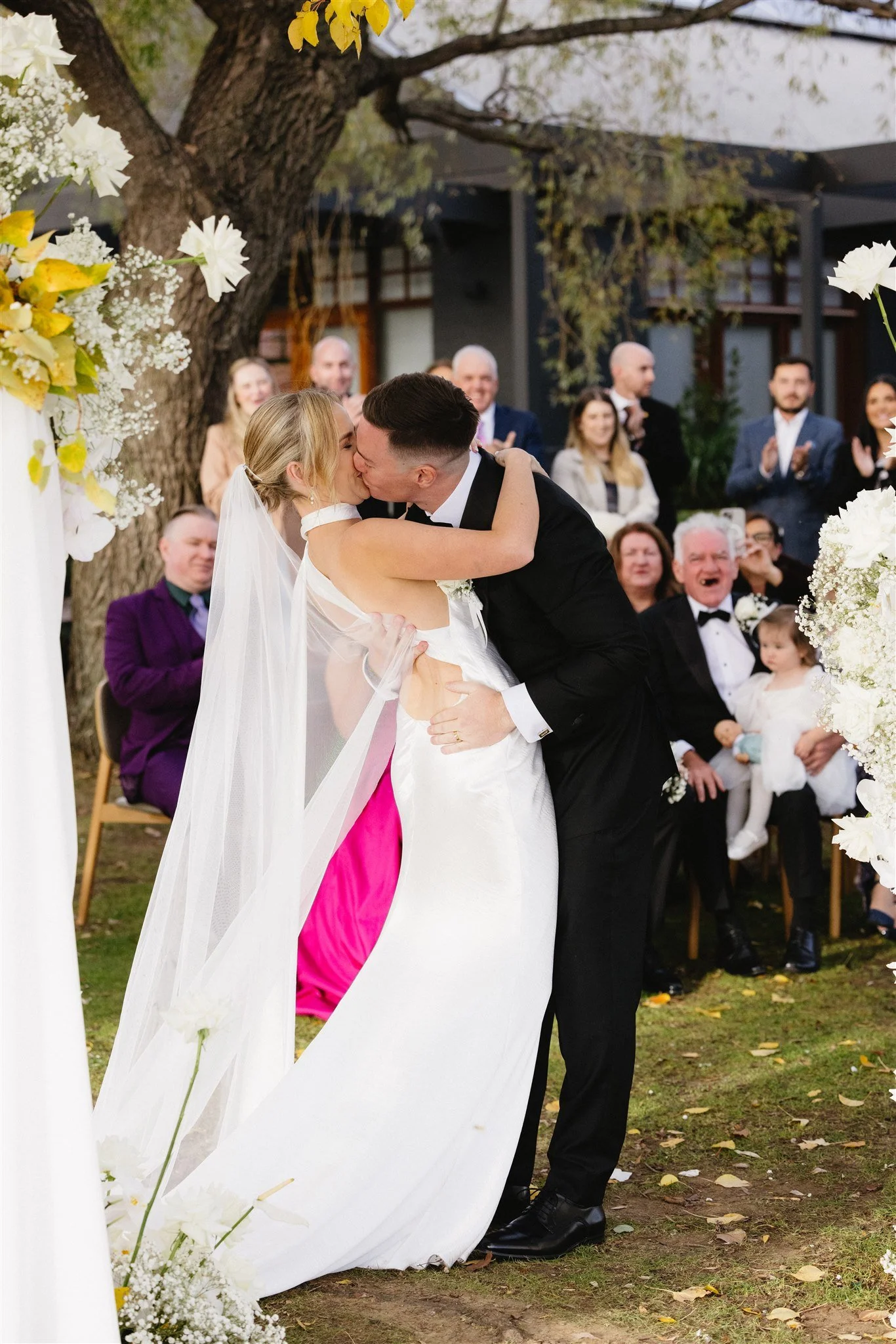 Bride and groom's first kiss during wedding ceremony at The Boat House in Canberra