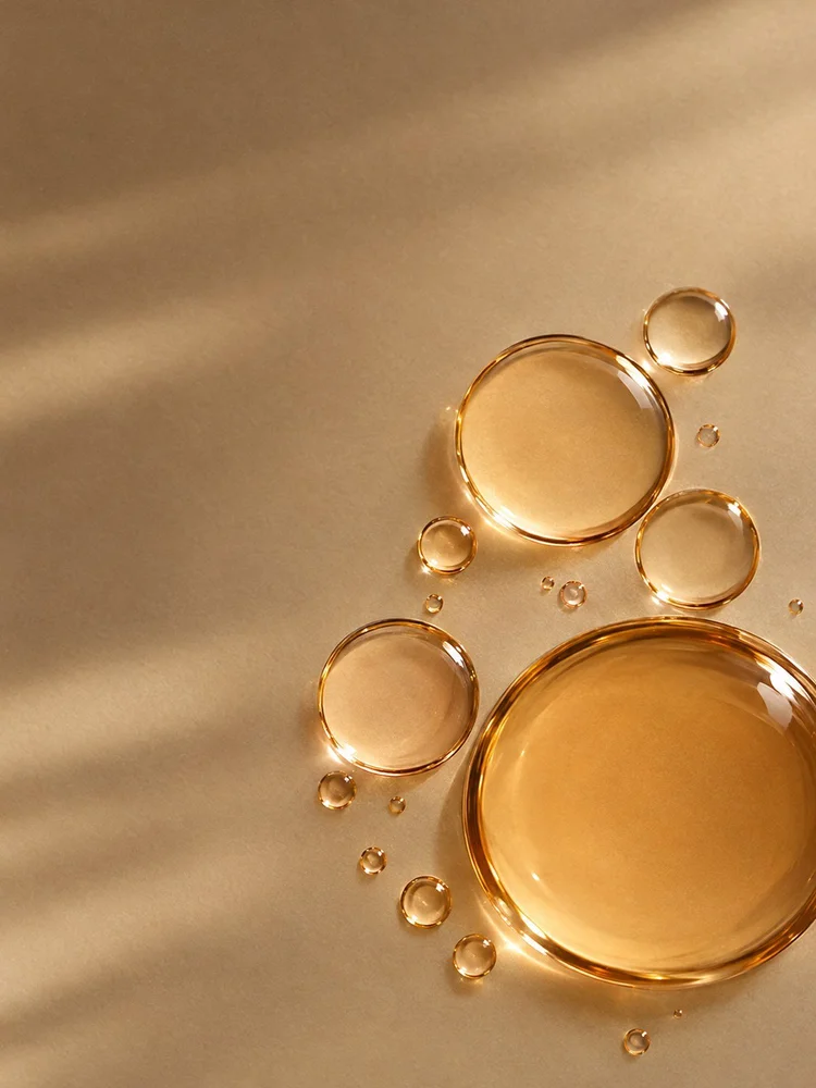 Clear droplets in warm amber light.