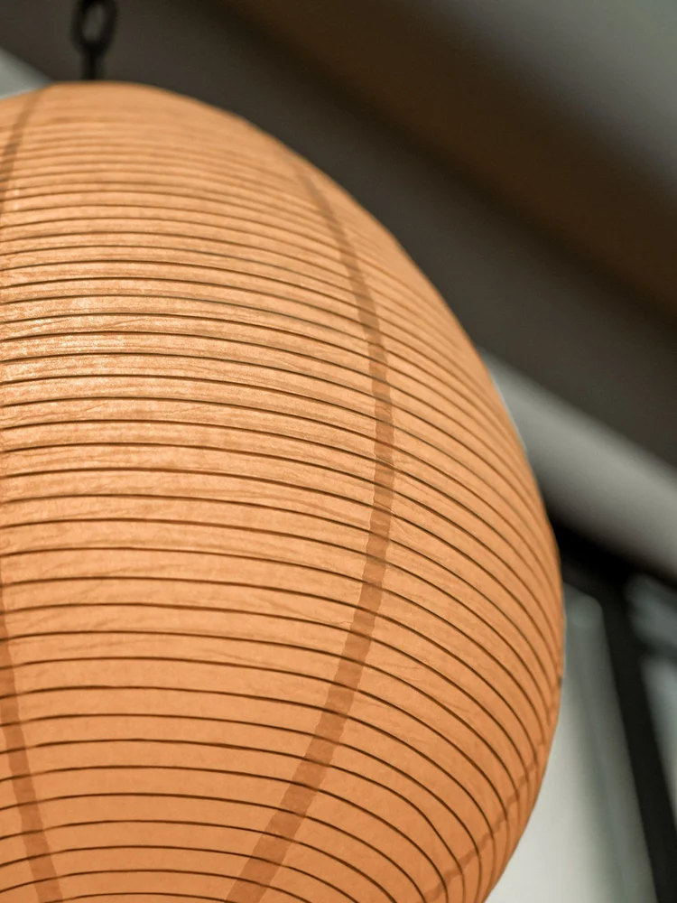Warm illuminated paper lantern photographed close up.