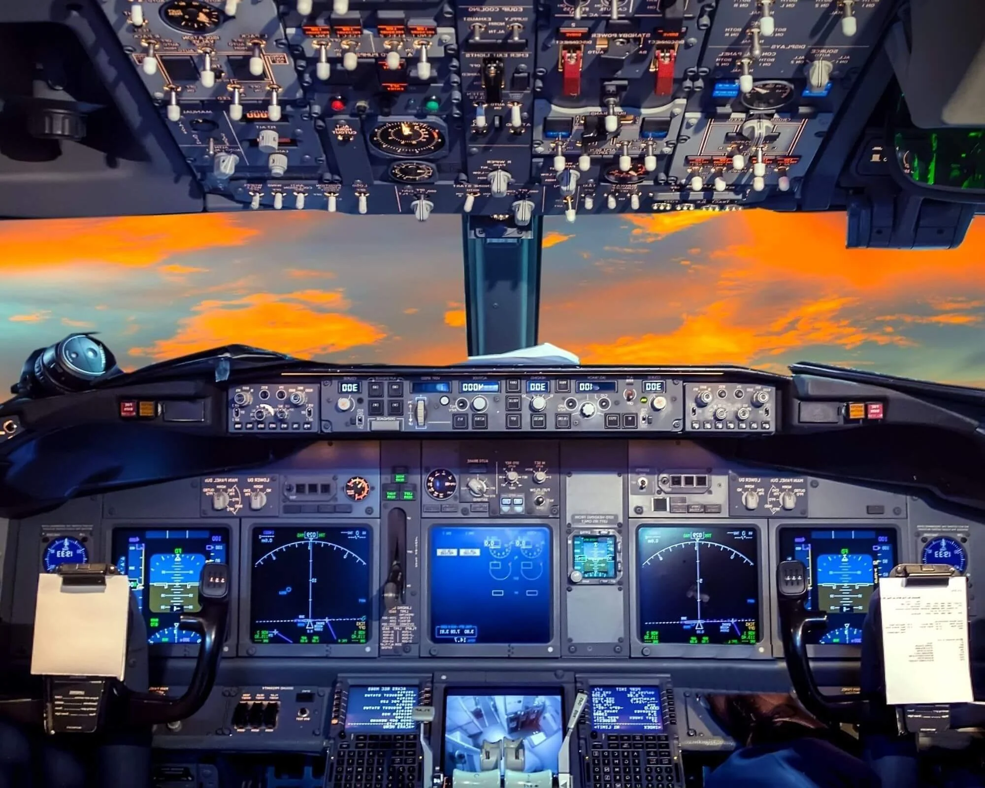 looking into the cock pit of an airplane at all the speed gauges and dials