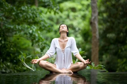 Woman meditating in a calm natural setting