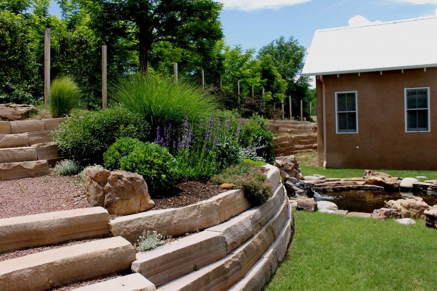 Rear courtyard terraces with edible, pollinator-attracting perennials and a recirculating pond. Snakes, frogs and aquatic insects abound!