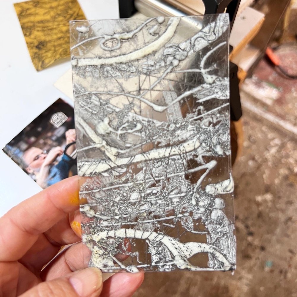 Encaustic collagraph plate made of clear plexiglass random white lines and bubble of wax