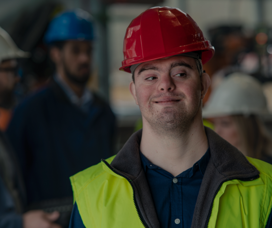 man with down's syndrome is at work in a high visibility jacket and red hard hat